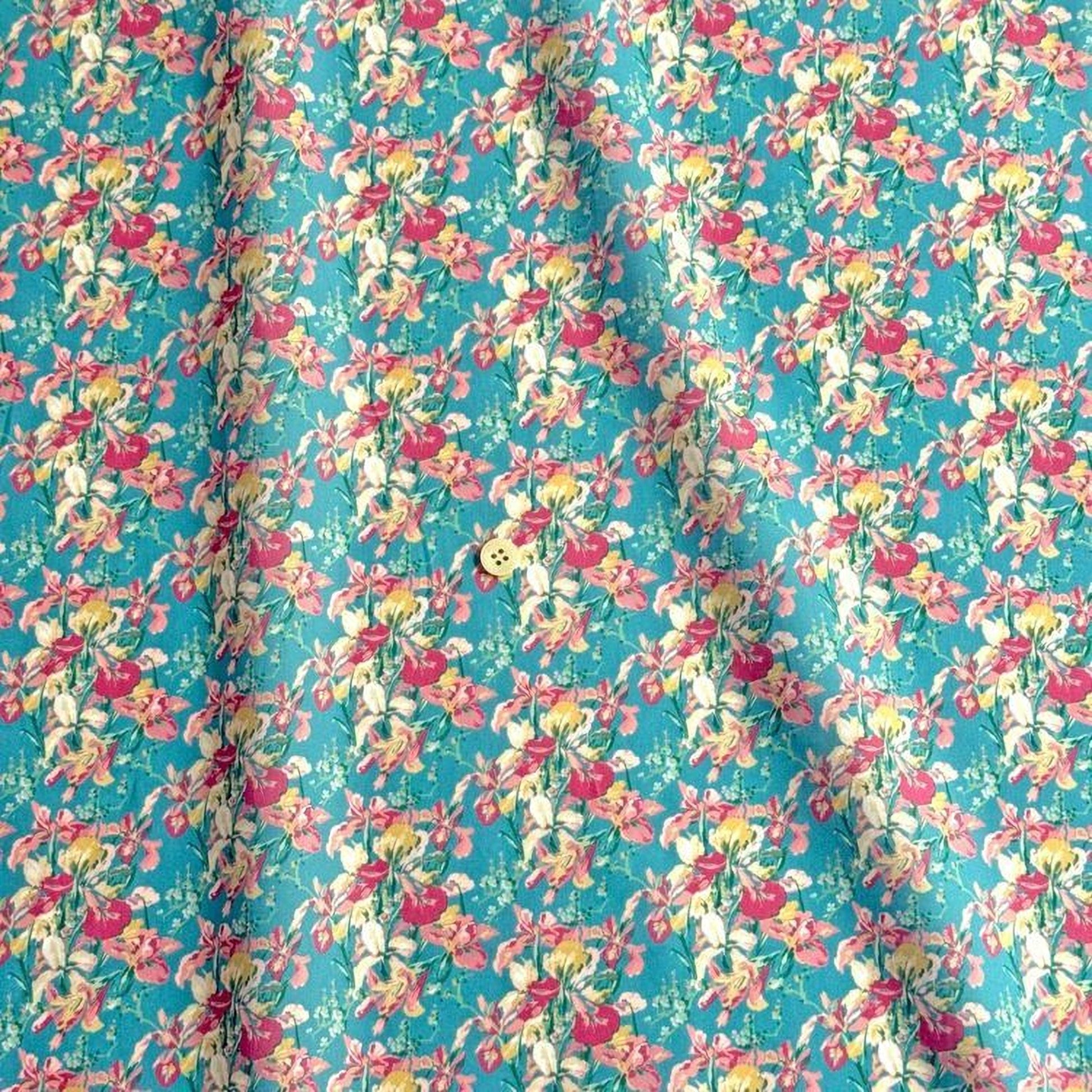 a fabric with a repeating floral pattern in shades of pink, yellow, and green. The pattern is vibrant and colorful, creating a lively and cheerful visual effect.