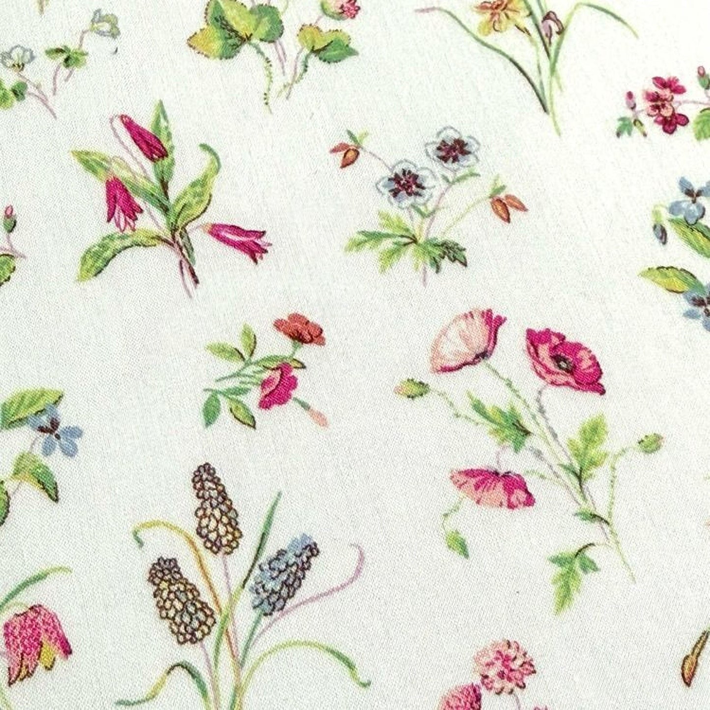 a variety of colorful flowers and plants, including poppies, lilies, and other blooms, arranged in a visually appealing manner.