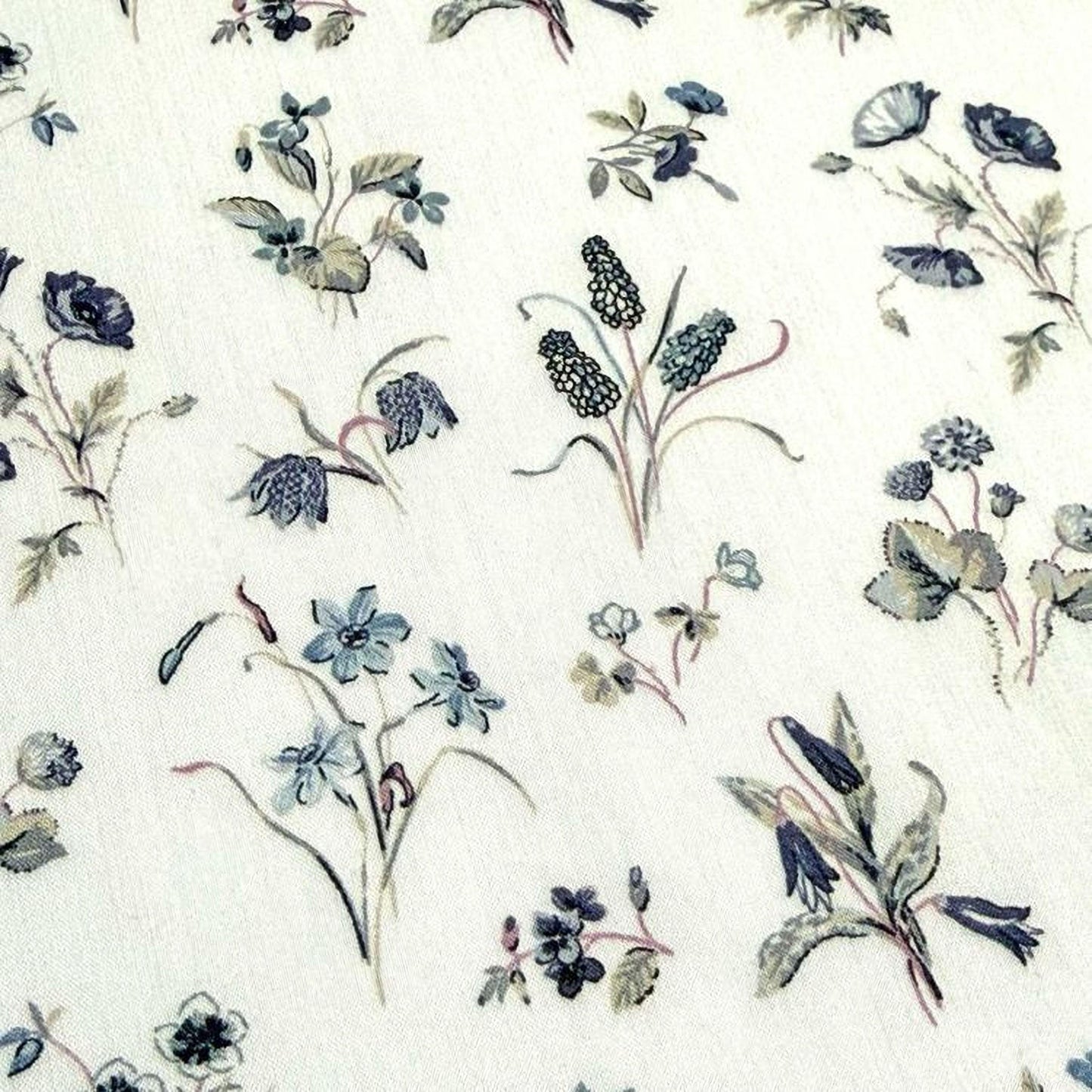 a variety of floral designs, including blue flowers, green leaves, and other natural elements, arranged in a repeating pattern.