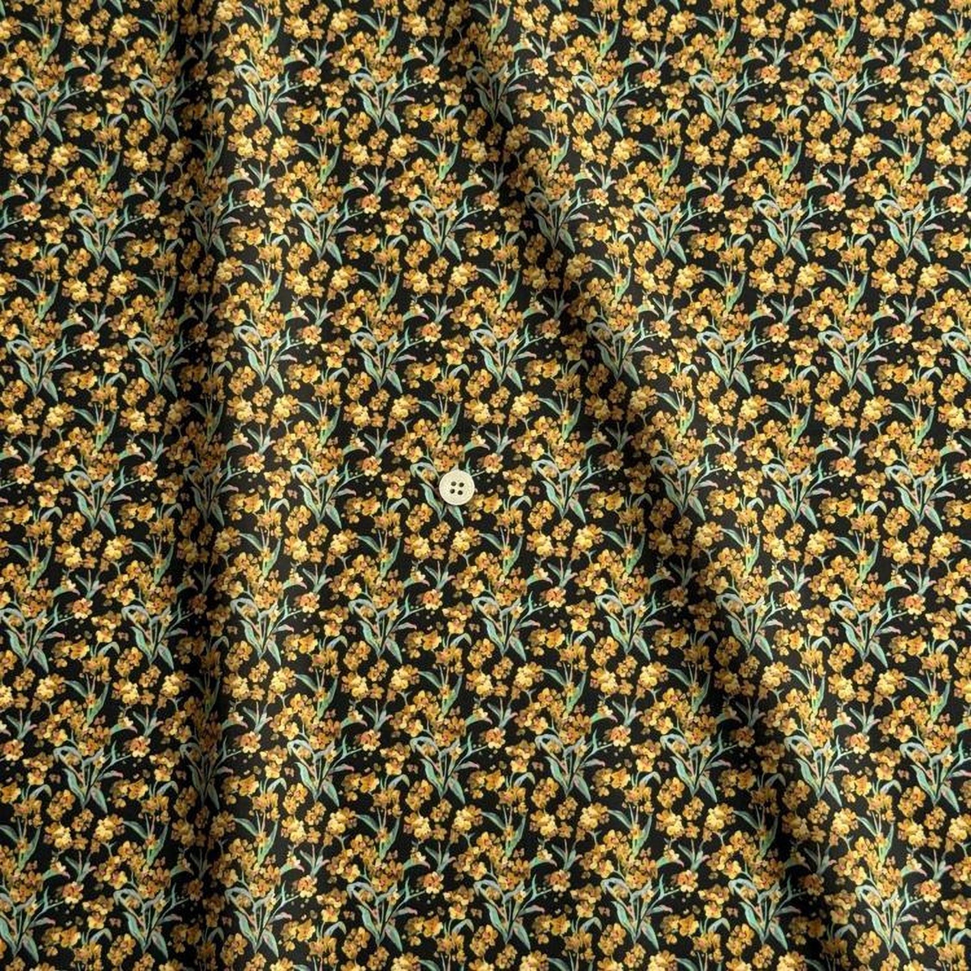 a close-up view of a fabric with a floral pattern in shades of yellow and black. The fabric appears to be made of a material with a subtle texture, and there is a small white button visible in the center of the fabric.