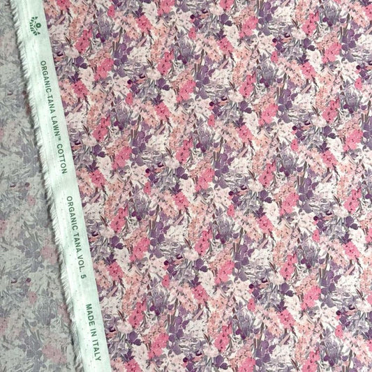 a fabric with a floral pattern in shades of pink and purple. The fabric appears to be made of organic cotton and is labeled as "Organic Lawn Cotton" and "Made in Italy".
