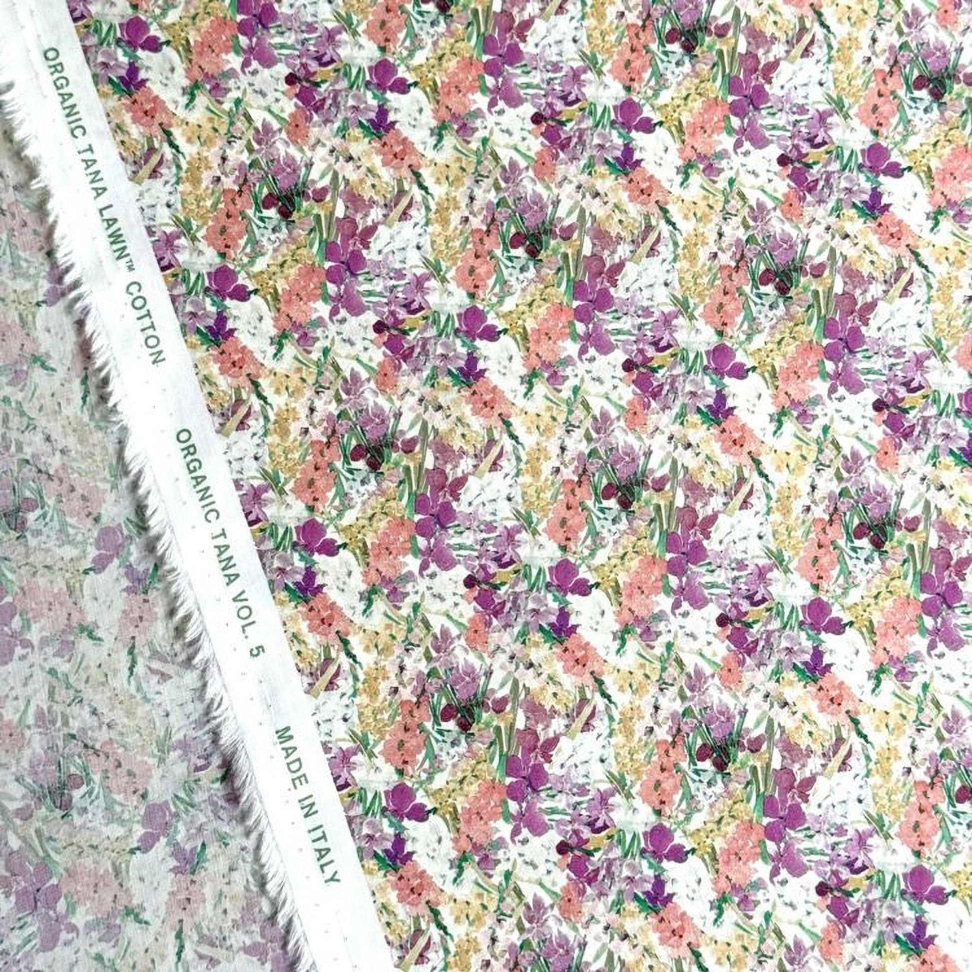 a fabric with a floral pattern, including various shades of pink, yellow, and green flowers. The fabric appears to be made of organic cotton and is displayed on a white background.