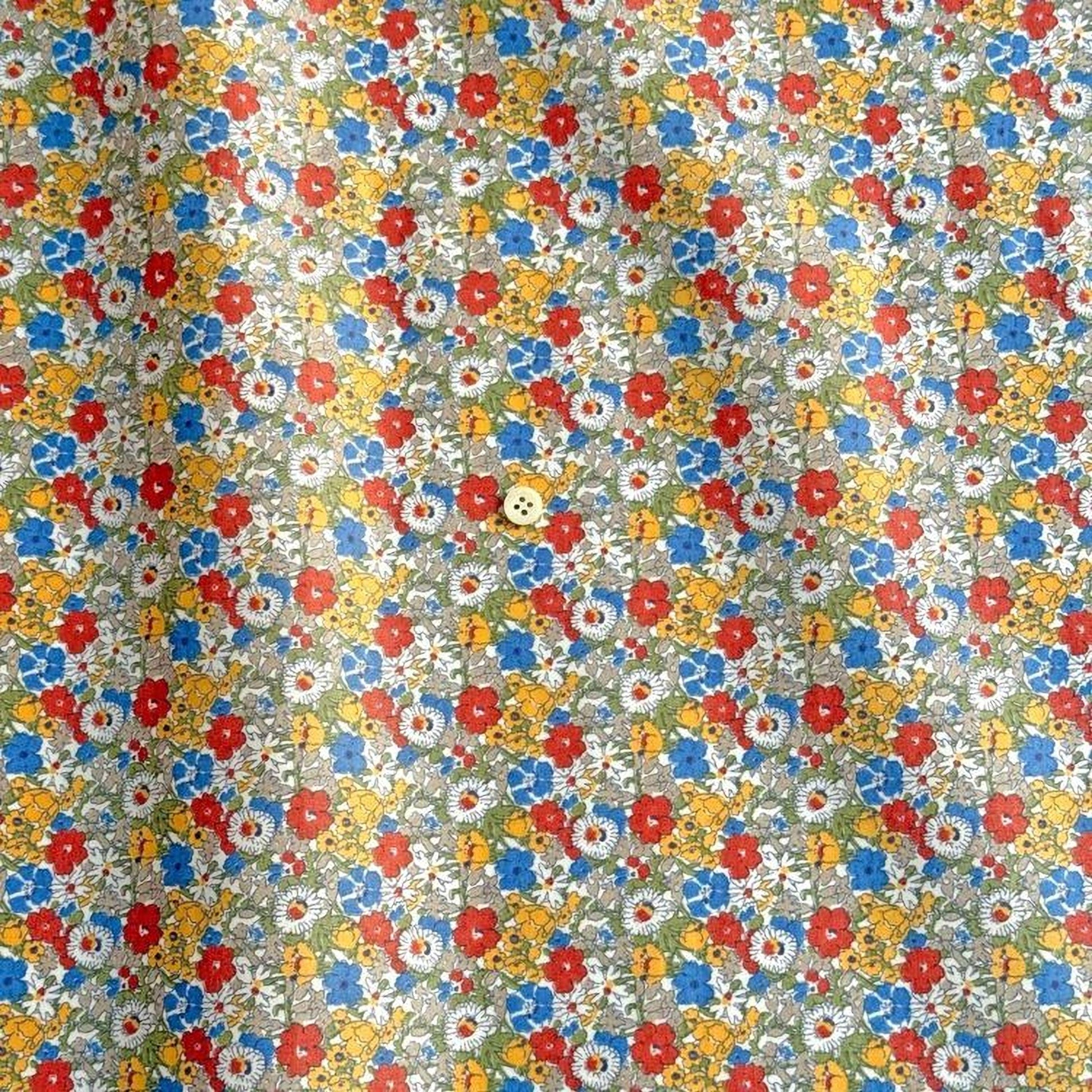 a vibrant, colorful floral print with a single button visible in the center.