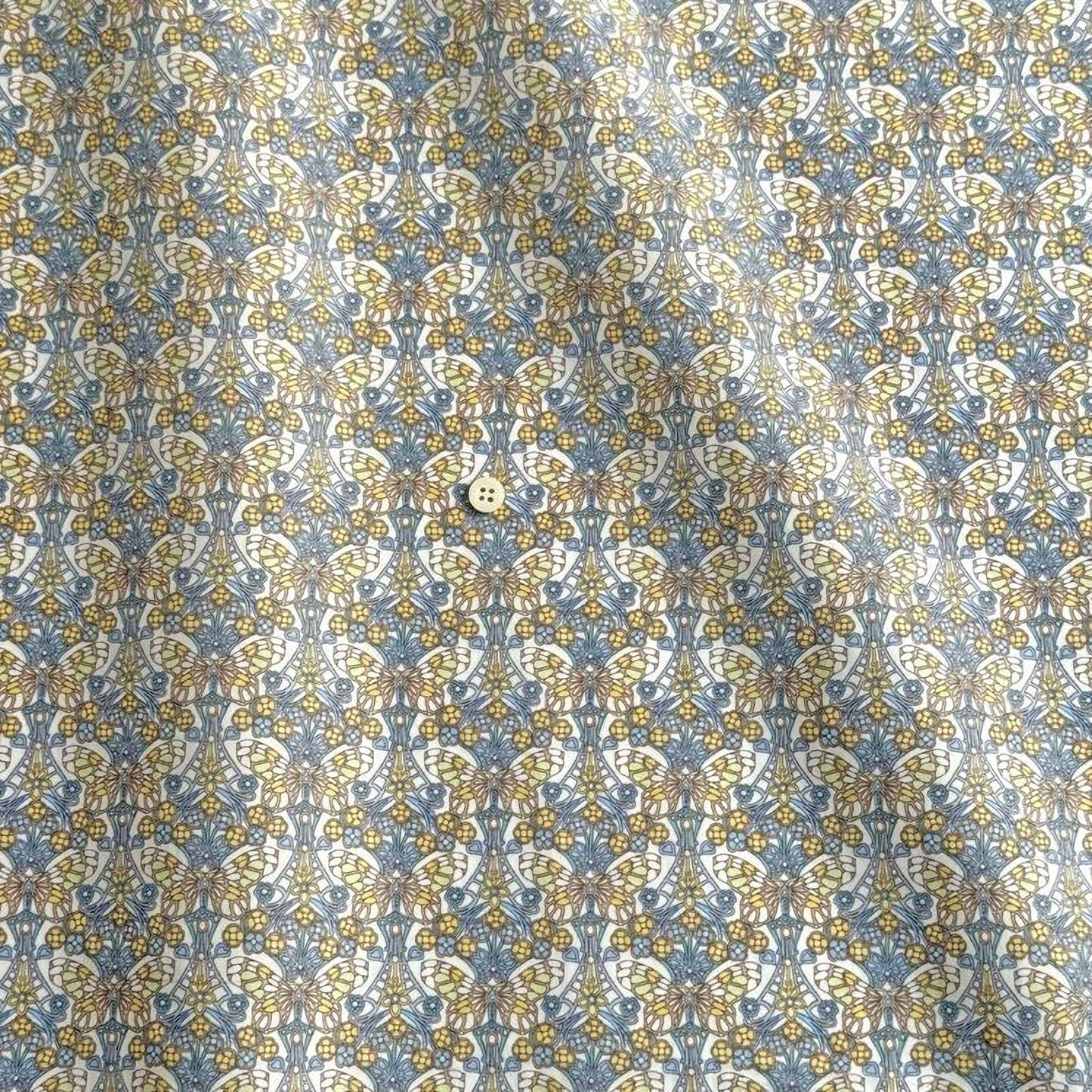 a repeating pattern of a floral design in shades of blue and yellow.