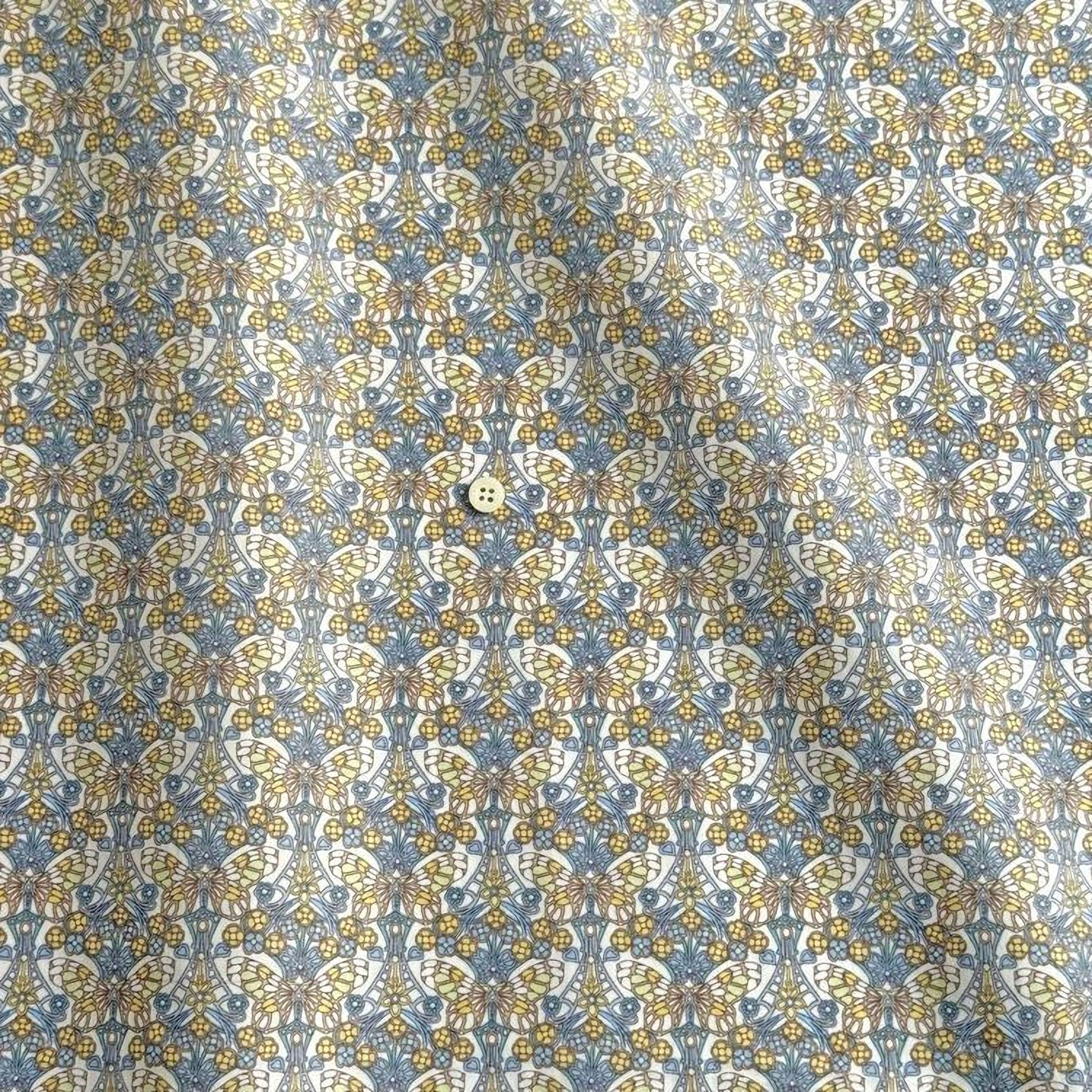 a repeating pattern of a floral design in shades of blue and yellow.