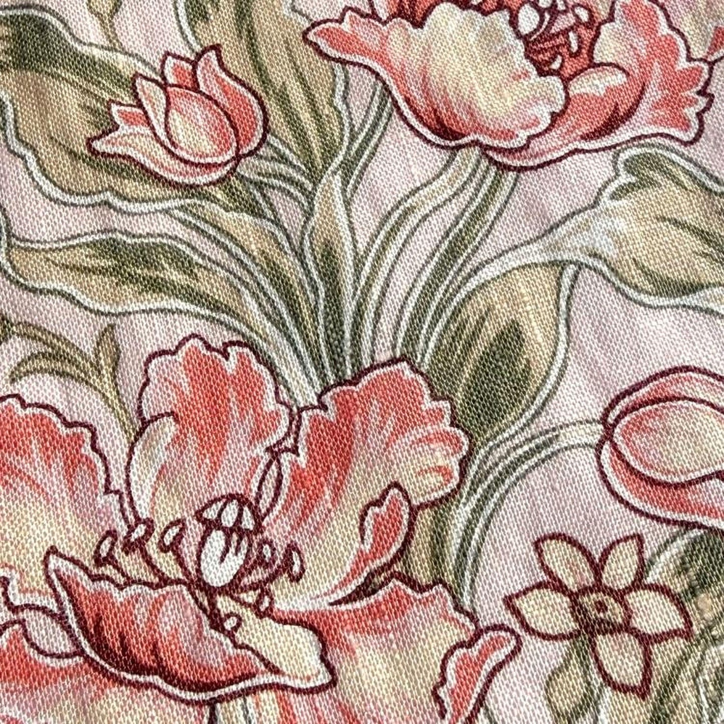 a close-up view of a fabric with a floral pattern. The pattern consists of pink and green flowers, along with leaves, creating a visually appealing and intricate design.