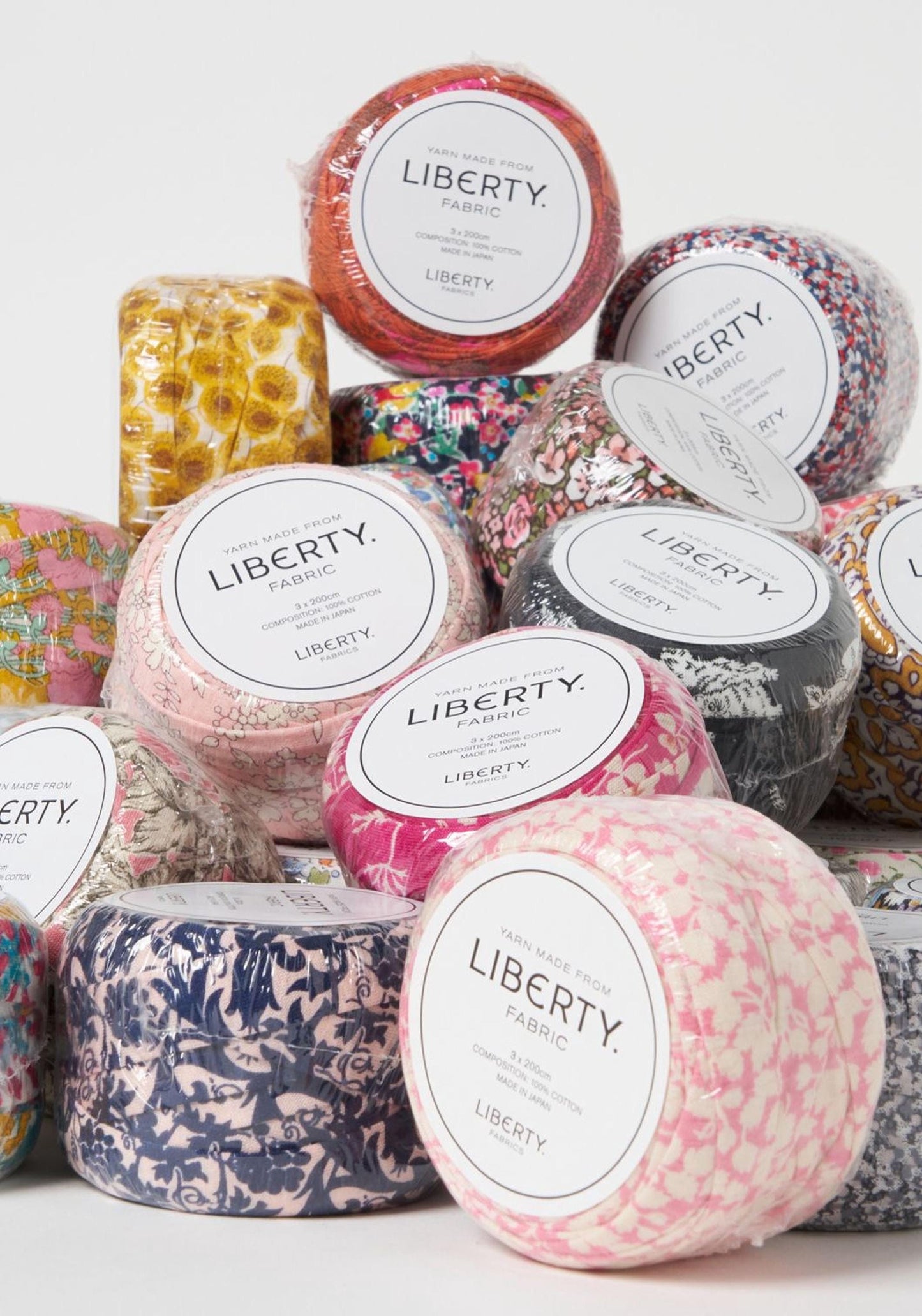 A collection of fabric swatches in various colors and patterns, with labels indicating they are made from "Liberty Fabric".