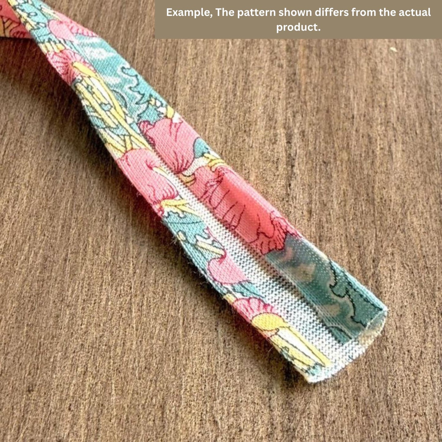 a colorful fabric with a floral pattern, lying on a wooden surface.