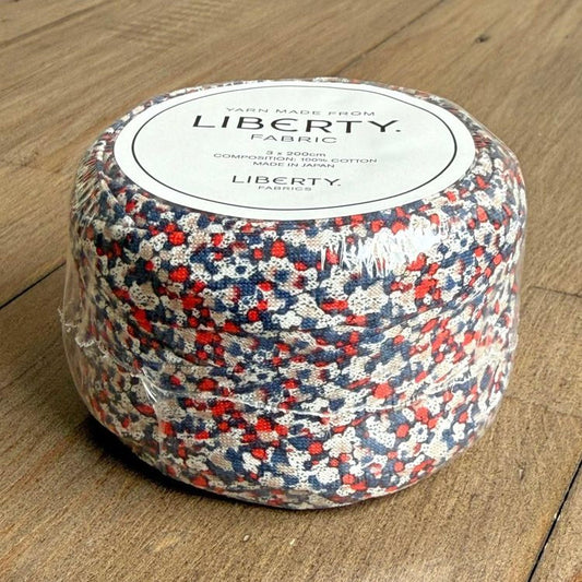 A package of fabric swatches in red, white, and blue colors, labeled as "Yarn made from LIBERTY Fabric" and "COMPONENT 100M LITRE COTTON".