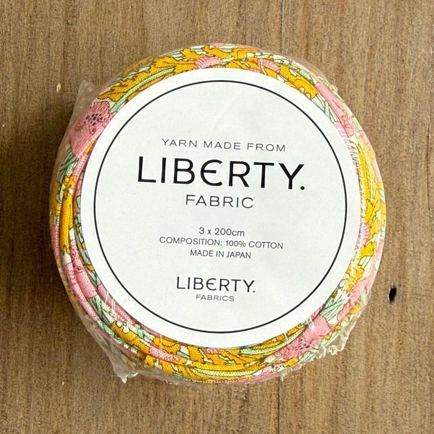 A package of Liberty fabric, with a label that reads "Yarn Made from LIBERTY. FABRIC 3 x 200cm COMPOSITION: 100% COTTON MADE IN JAPAN LIBERTY FABRICS".