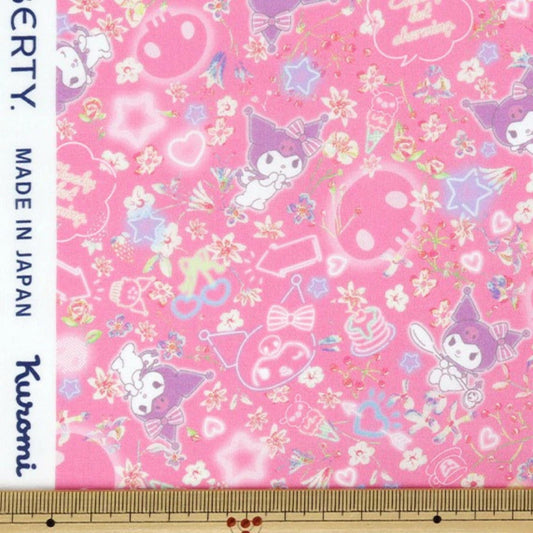 The image is a fabric with a pink background and various cartoon-like characters, including a character wearing a hat and bow, as well as other whimsical elements.