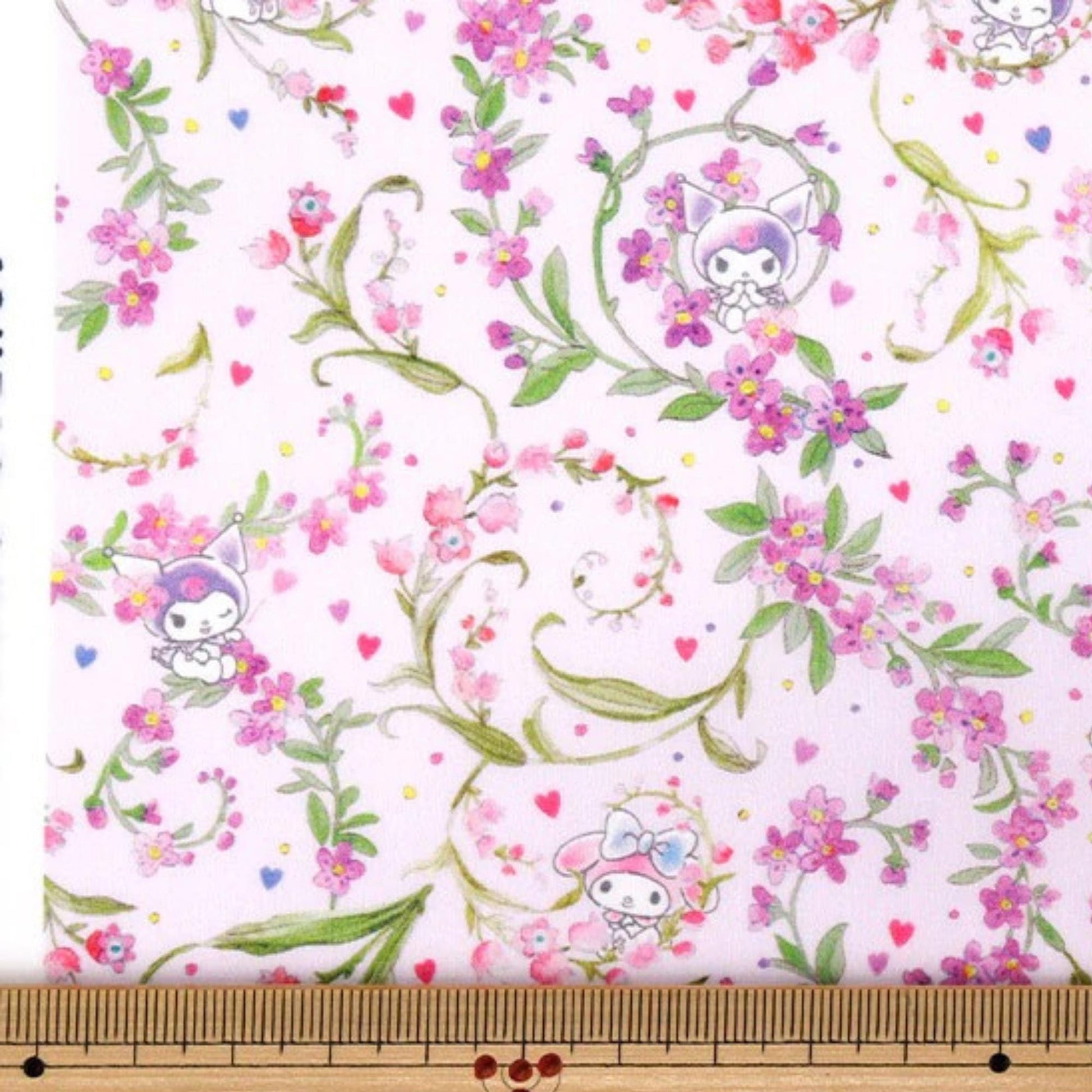 a repeating floral pattern with pink flowers and green leaves, along with small cartoon-like characters.