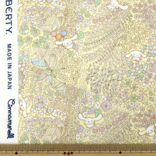 The image is a vibrant and colorful fabric with a repeating pattern of various elements, including flowers, leaves, and small animals. The fabric appears to be made of a material that resembles paper, with a yellow and green color scheme. The image is not a single, continuous scene but rather a collage of multiple images that come together to create a larger, more intricate pattern.