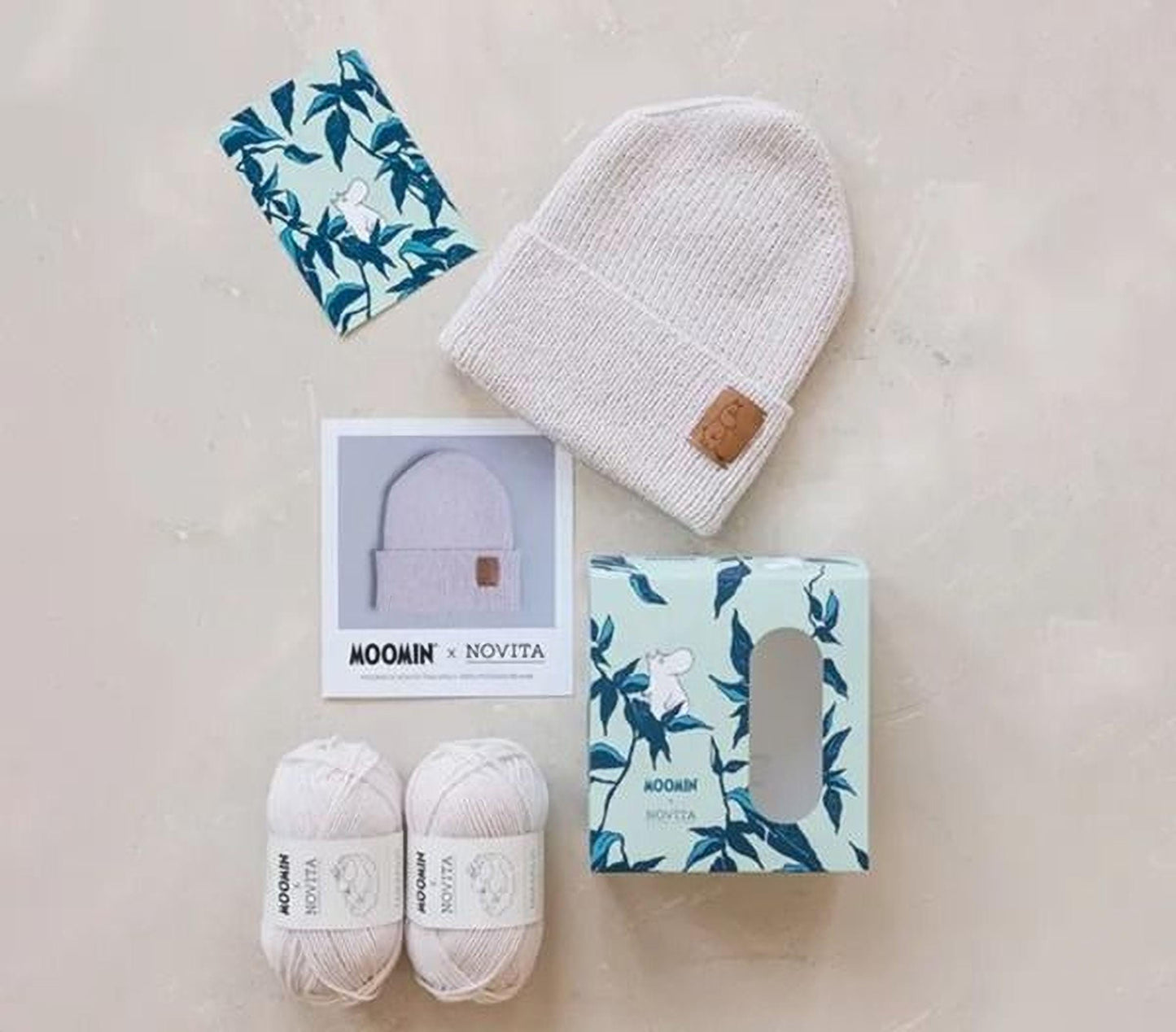 various items related to knitting and crochet, including yarn, a hat, a box, and some text.