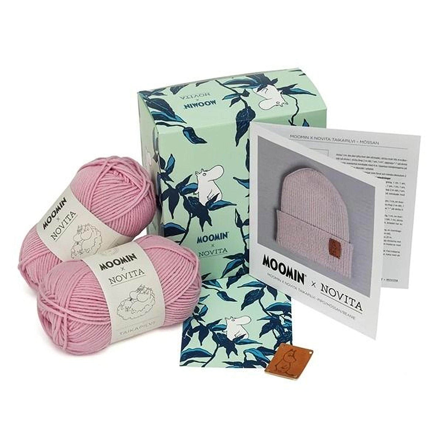 a collection of knitting supplies, including yarn, a box, and a booklet, all related to the Moomin brand.