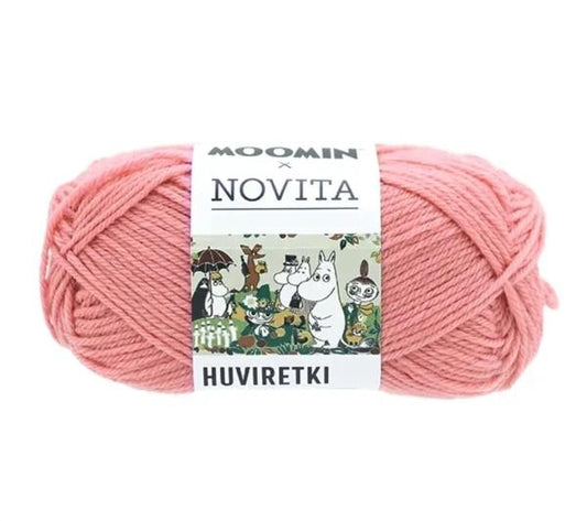 A ball of pink yarn with a label that reads "MOOMIN NOVITA HUVIRETKI" and features a cartoon image of a group of animals.