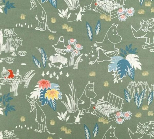 The image is a fabric with a repeating pattern of various animals, plants, and other elements, including flowers and leaves, all set against a green background.