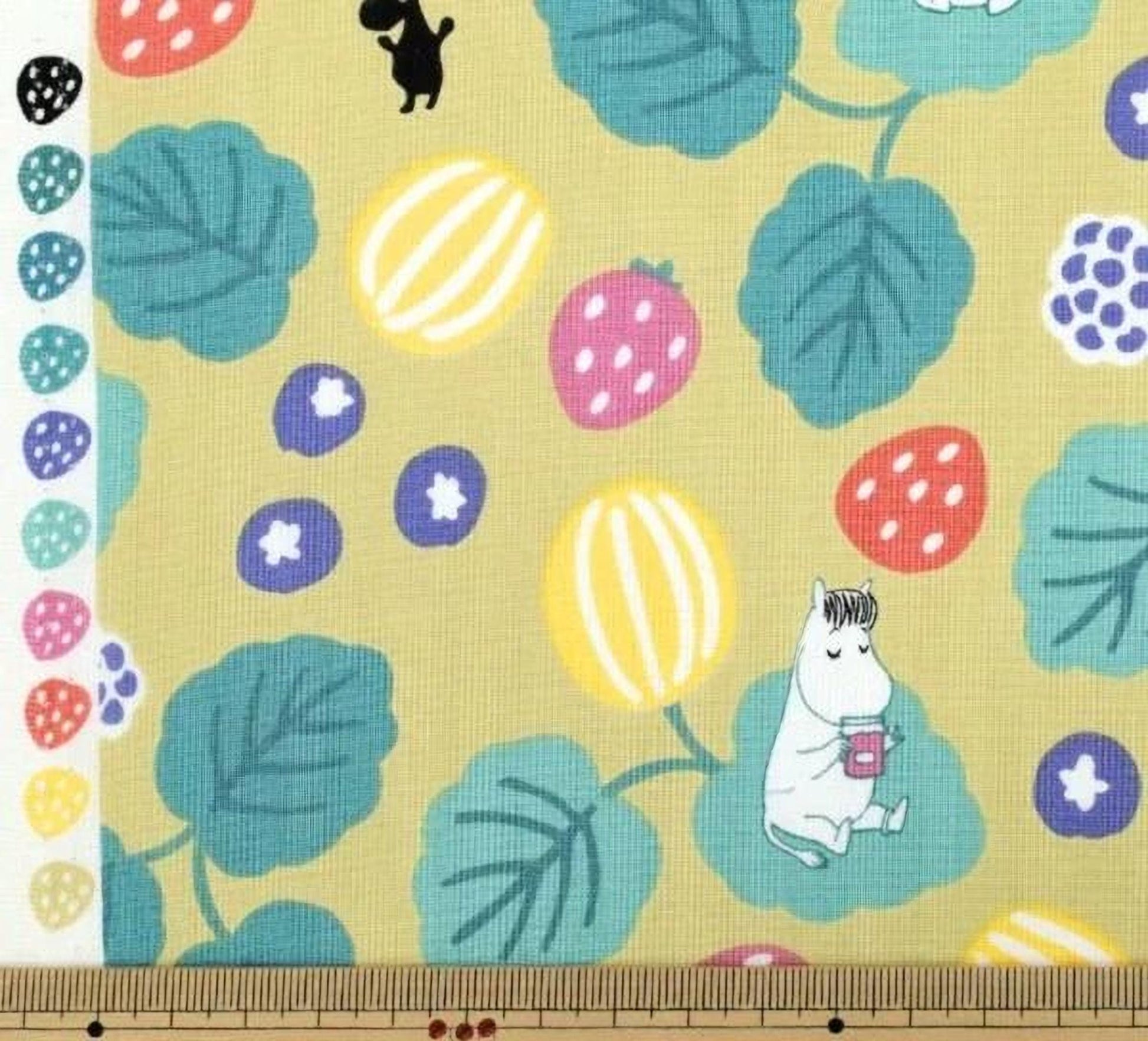 a vibrant and playful pattern of fruits and leaves, including strawberries, blueberries, and green leaves, along with a small illustration of a character.