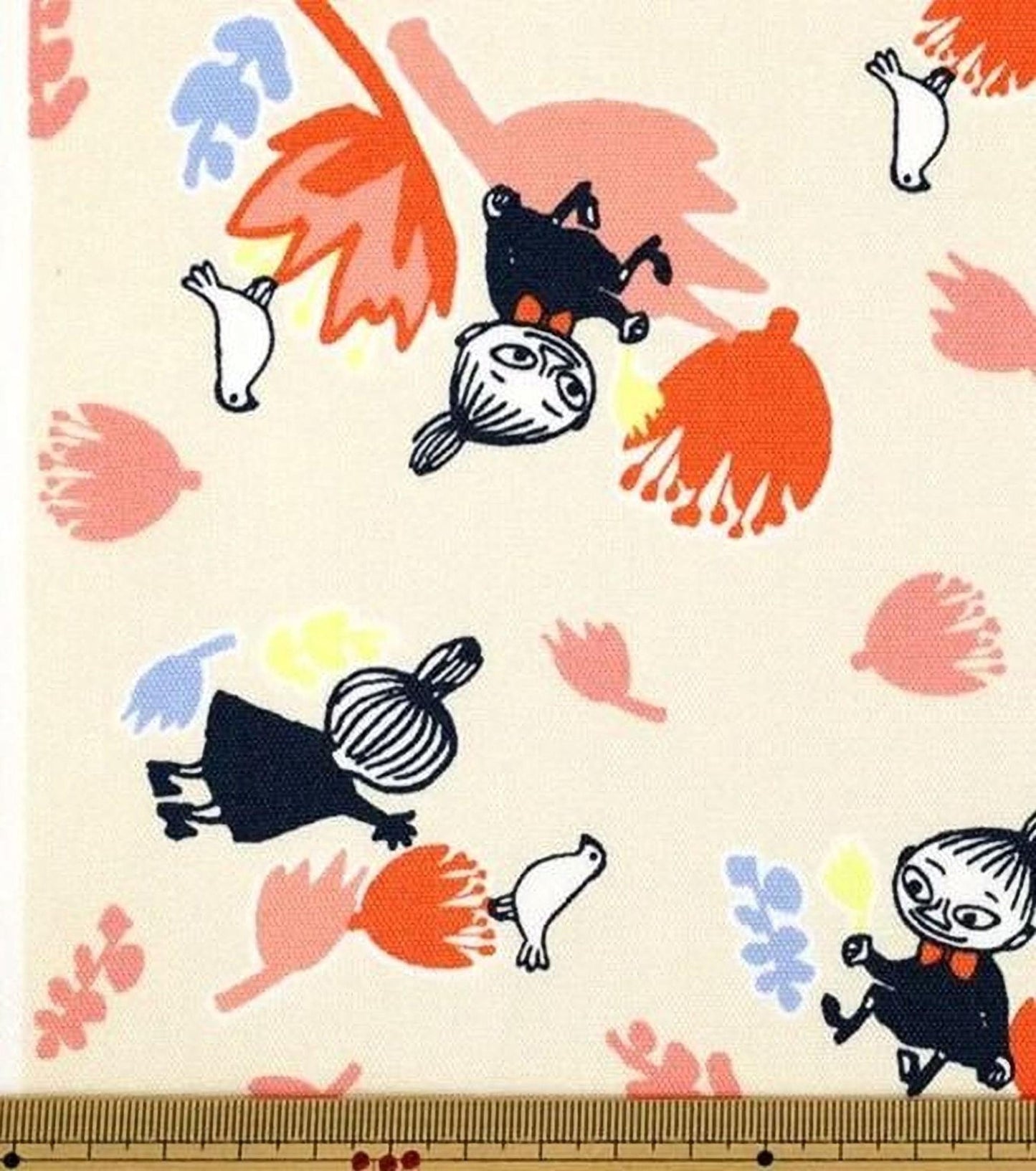The image is a fabric print featuring a playful and whimsical design with various cartoon-like characters and floral elements.