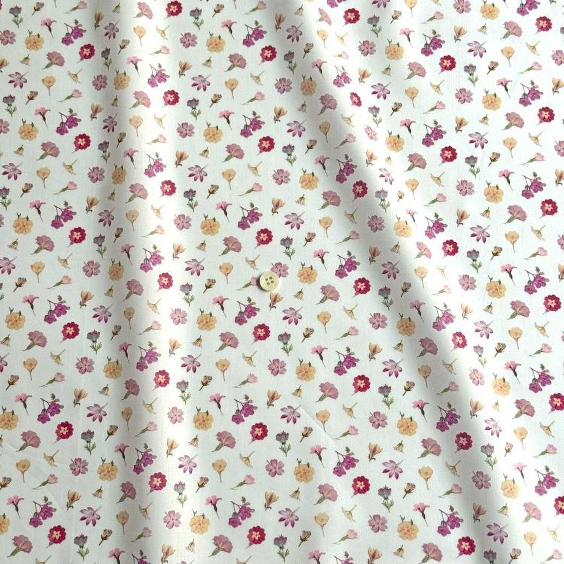a fabric with a repeating pattern of various colorful flowers, including pink, yellow, and purple flowers, against a white background.