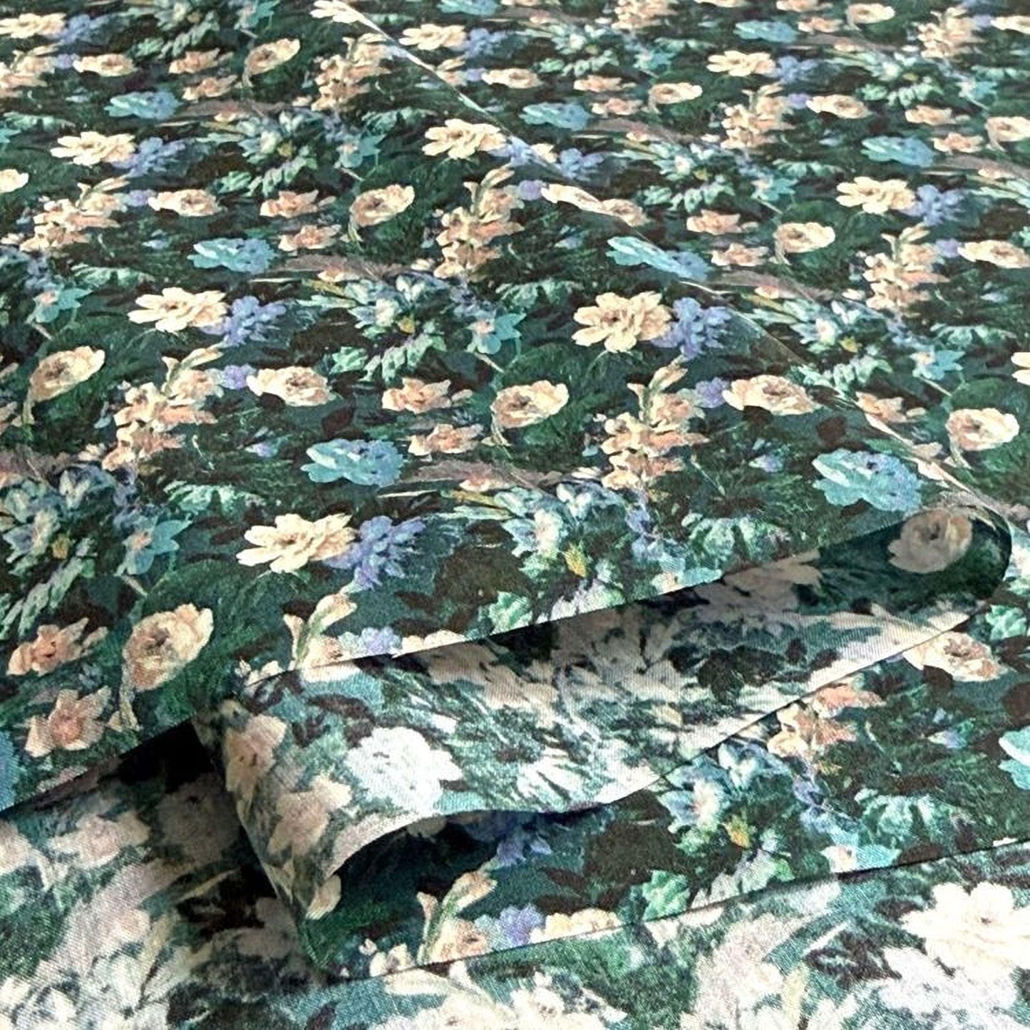 a close-up view of a fabric with a floral pattern, featuring a variety of colors and shapes.