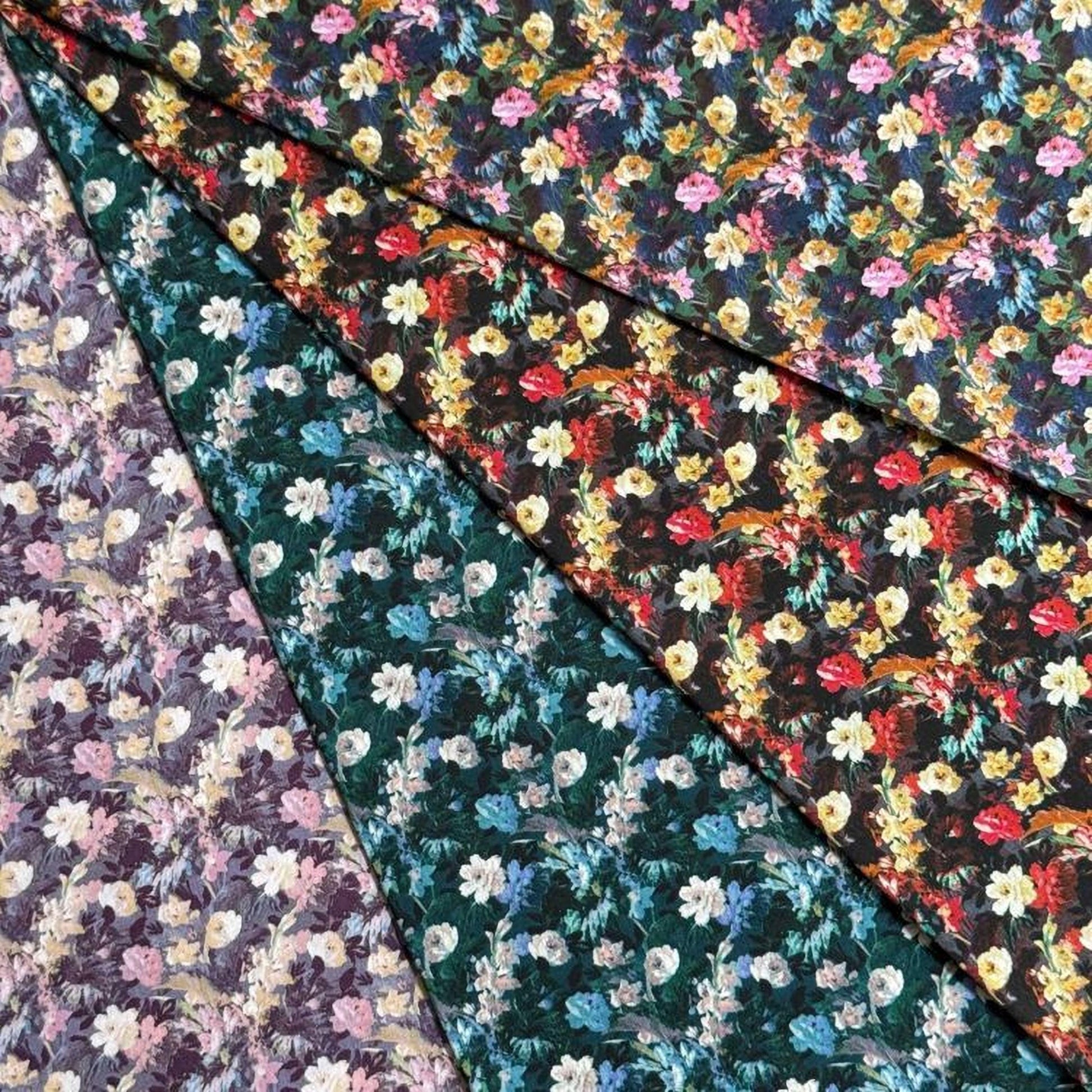 a collection of fabric swatches with various floral patterns, including a mix of dark and light colors, as well as different types of flowers and foliage.