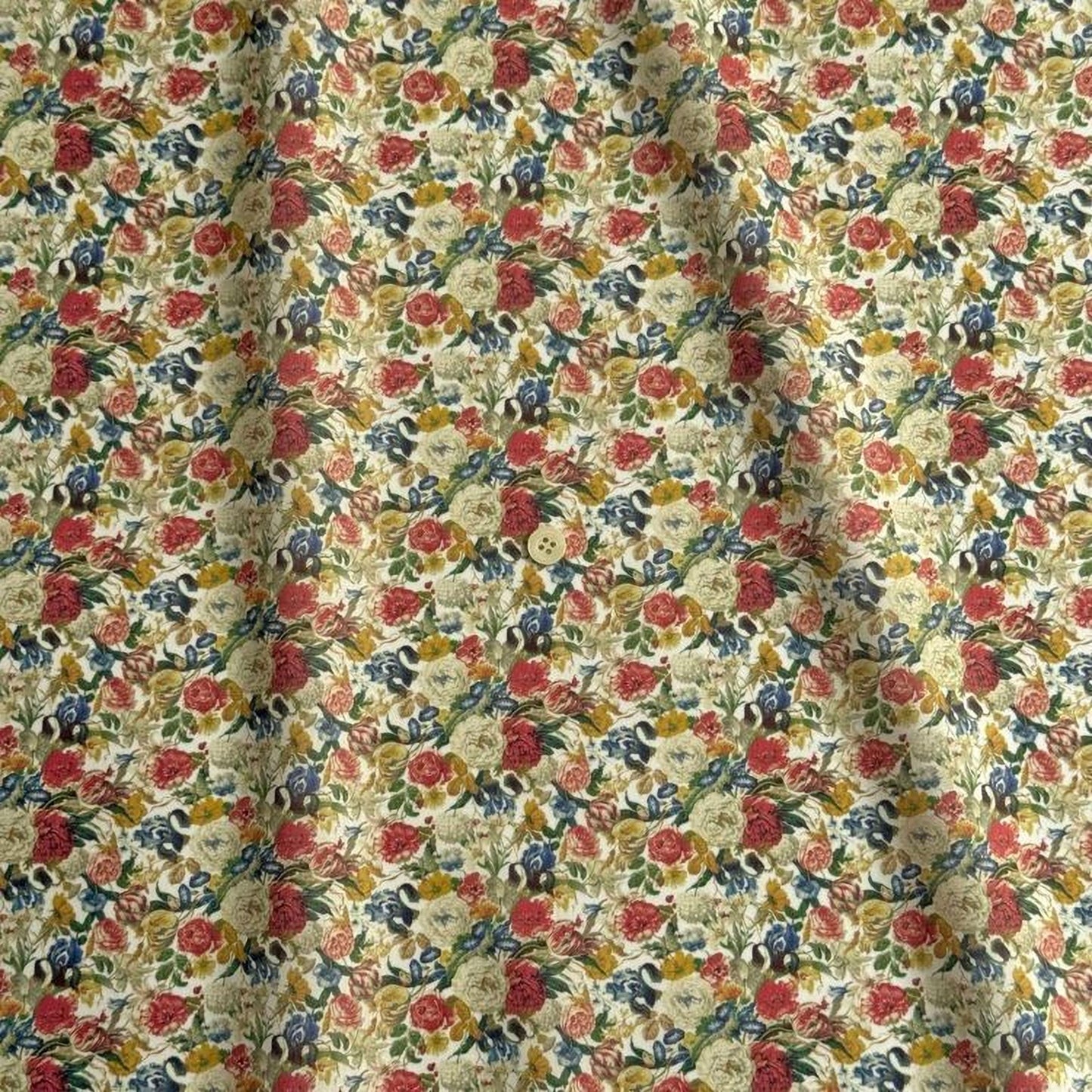 a fabric with a floral print pattern, featuring a variety of colorful flowers and leaves. The pattern is composed of numerous small flowers and leaves, creating a visually appealing and intricate design.