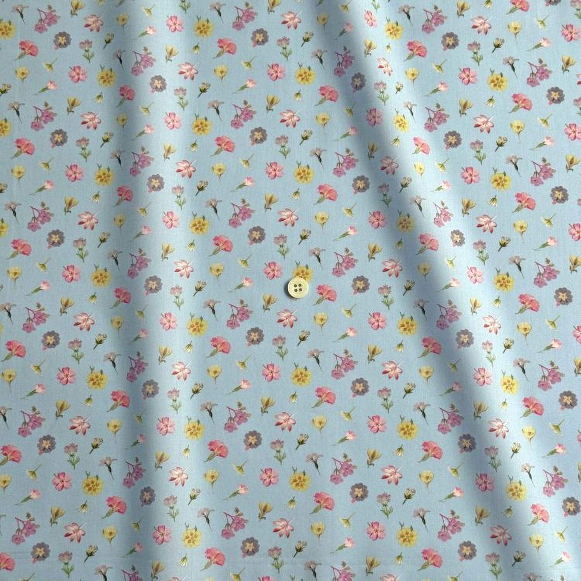 a fabric with a repeating pattern of small flowers in various colors, including pink, yellow, and purple. The pattern is spread across the fabric, creating a visually appealing and colorful design.