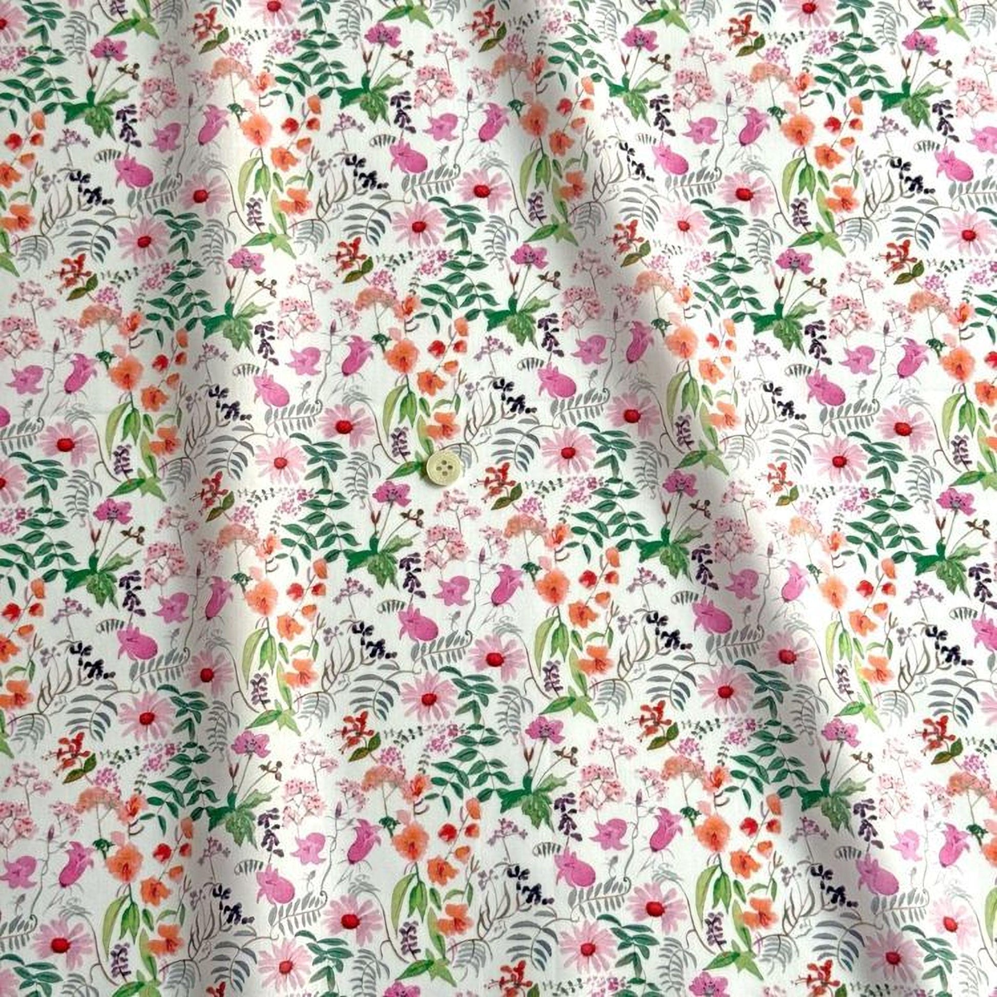 a close-up view of a fabric with a floral pattern. The pattern consists of various flowers and leaves in different colors, including pink, orange, green, and purple. The fabric appears to be made of a soft, white material, and the pattern is intricate and detailed.