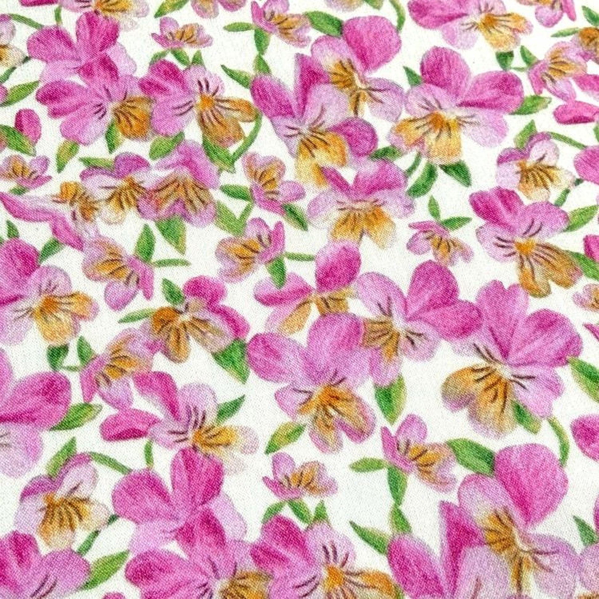The image is a close-up of a fabric with a repeating pattern of pink and yellow flowers.