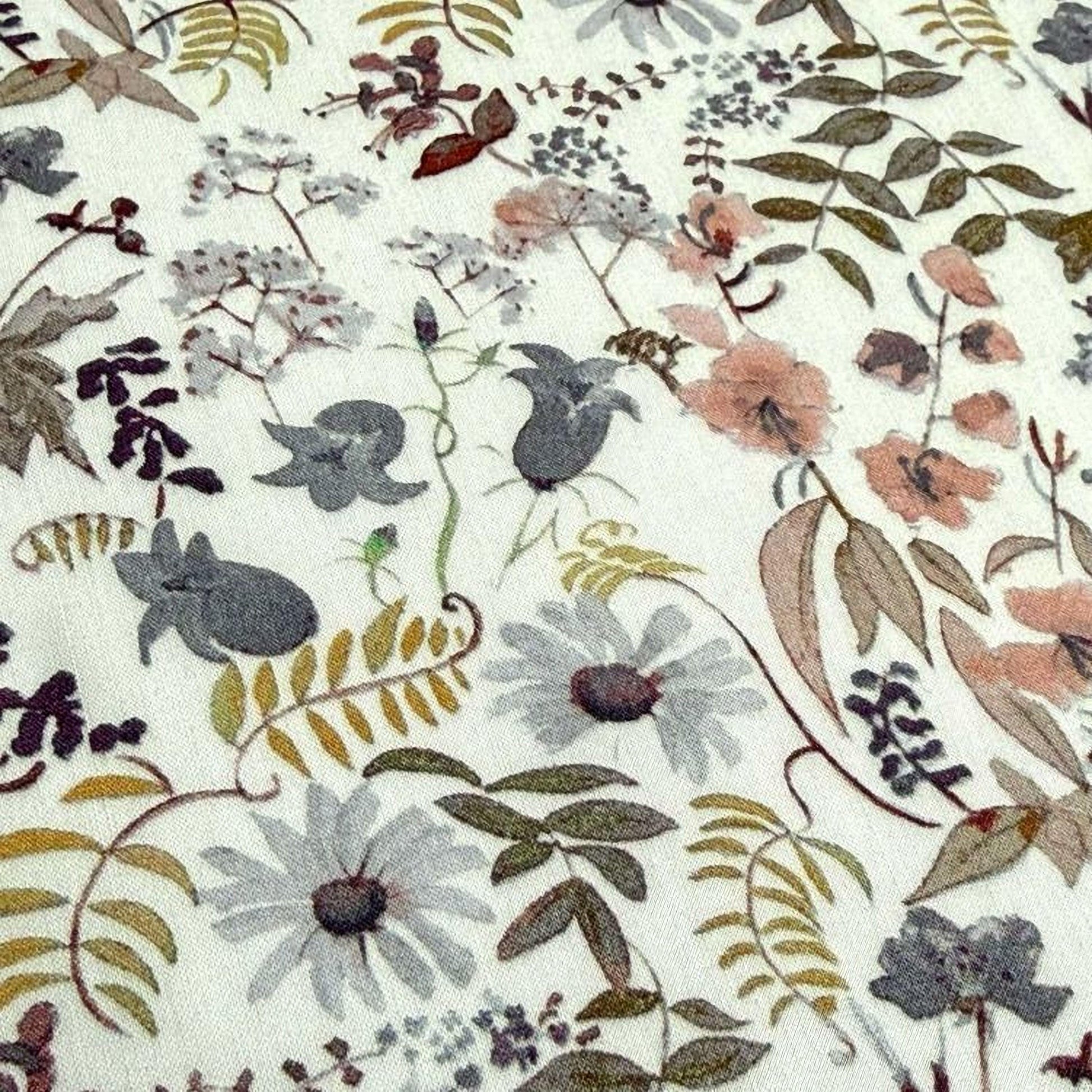 The image is a close-up of a fabric with a floral pattern, featuring various flowers, leaves, and other natural elements.