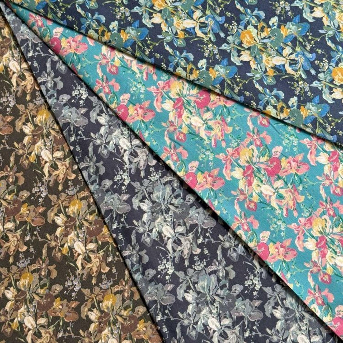 a collection of fabric swatches with various floral patterns, including a mix of dark and light colors.