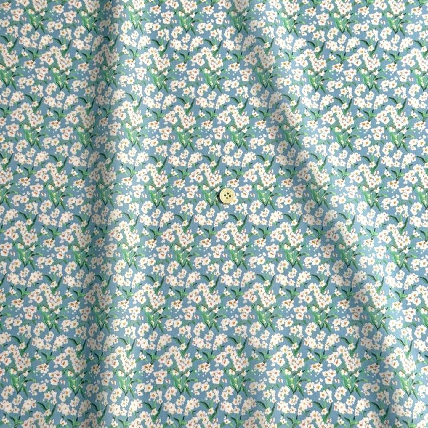 a fabric with a repeating pattern of white flowers against a light blue background.