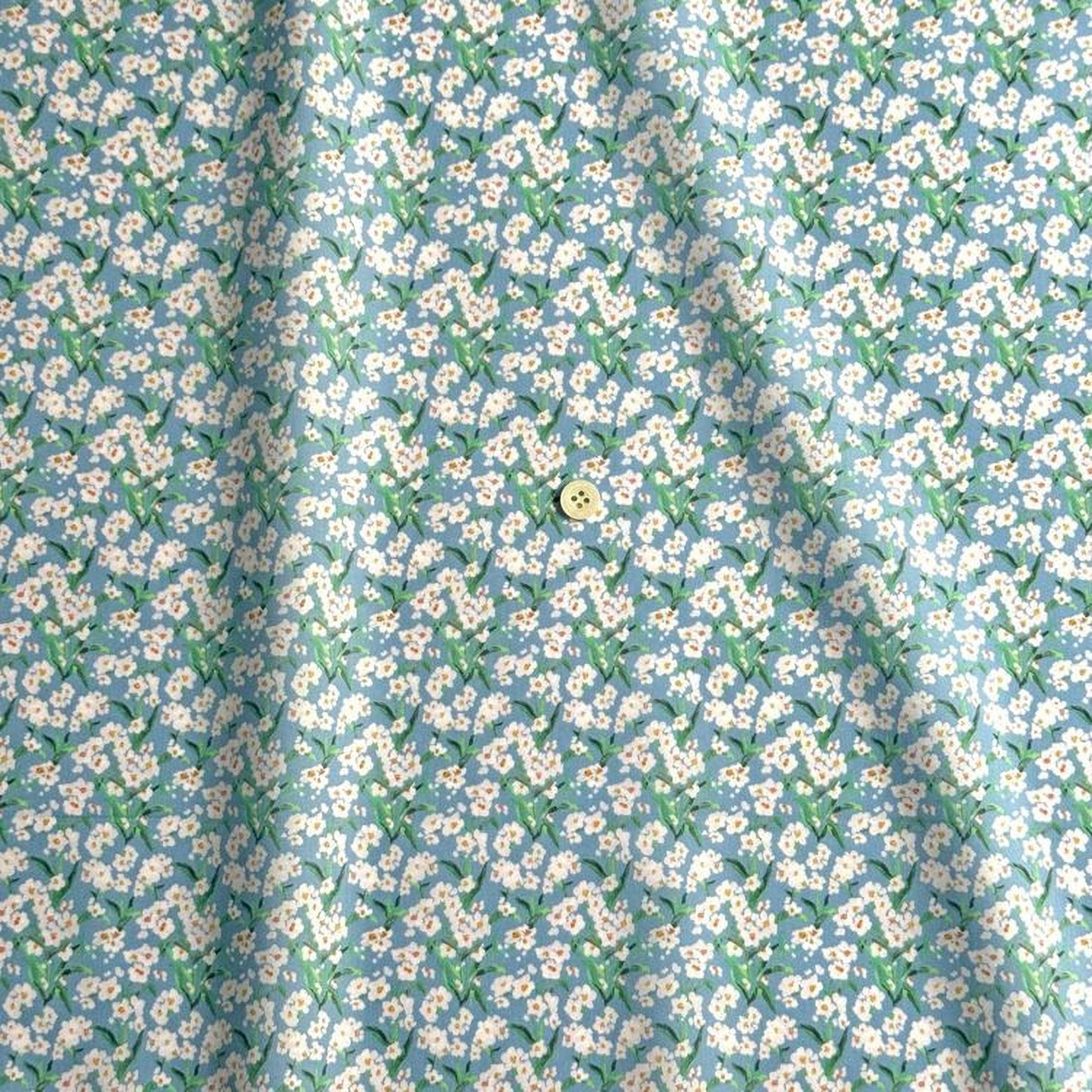 a fabric with a repeating pattern of white flowers against a light blue background.