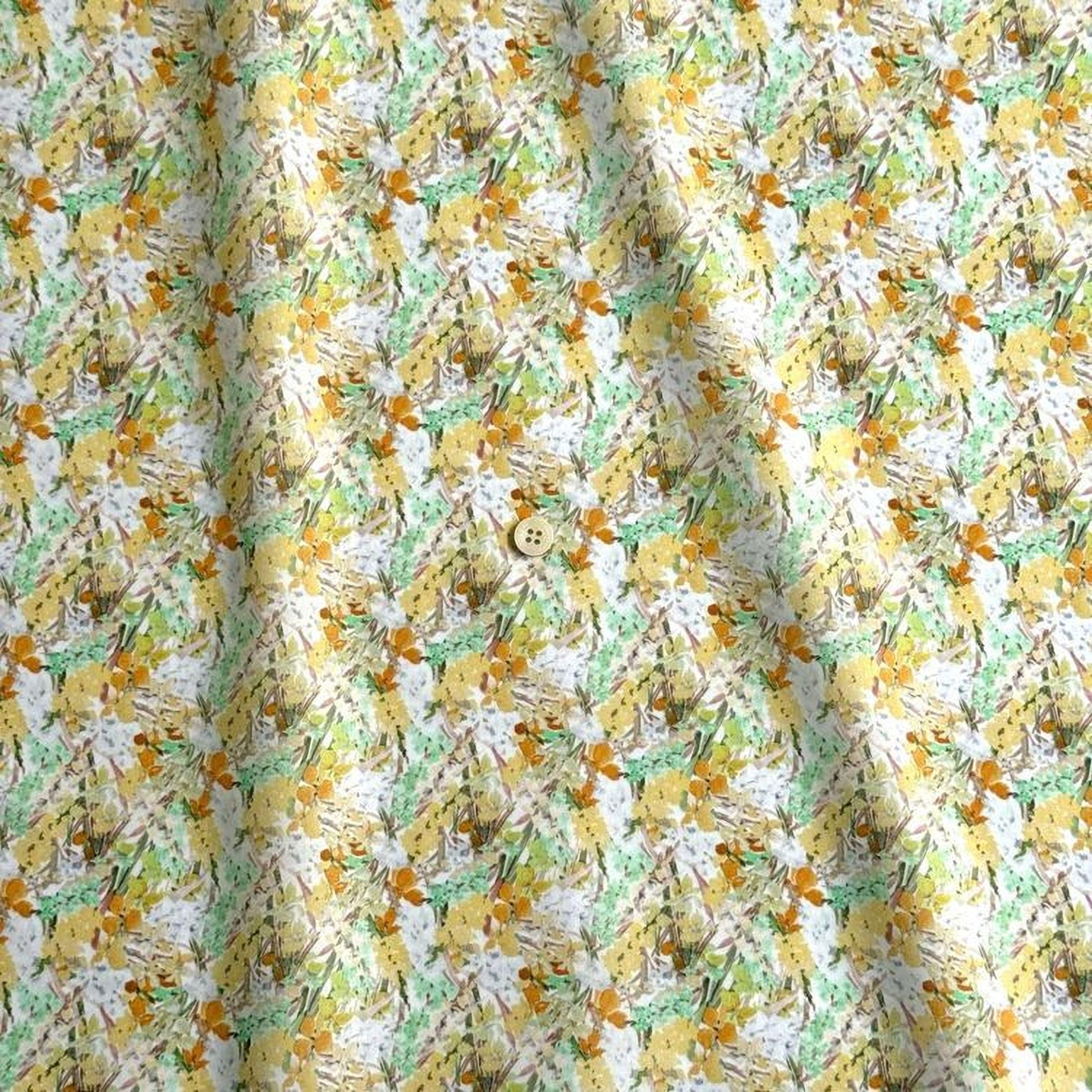 The image is a close-up of a fabric with a repeating pattern of yellow and green flowers, along with some green leaves. The fabric appears to be made of a soft, textured material, and there is a small button visible in the center of the pattern.
