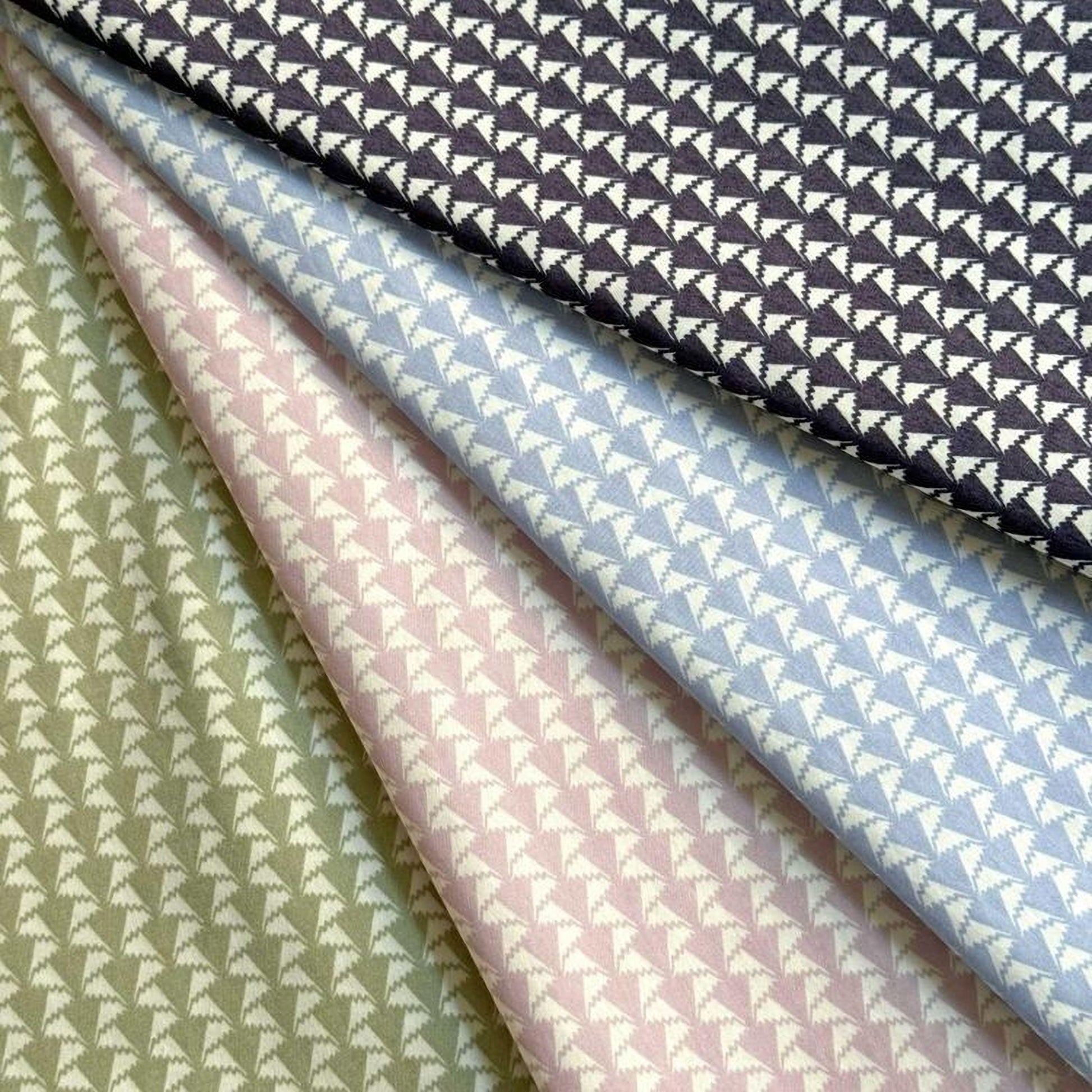 a collection of fabric swatches with a repeating pattern of triangles in various colors, including green, pink, blue, and black.