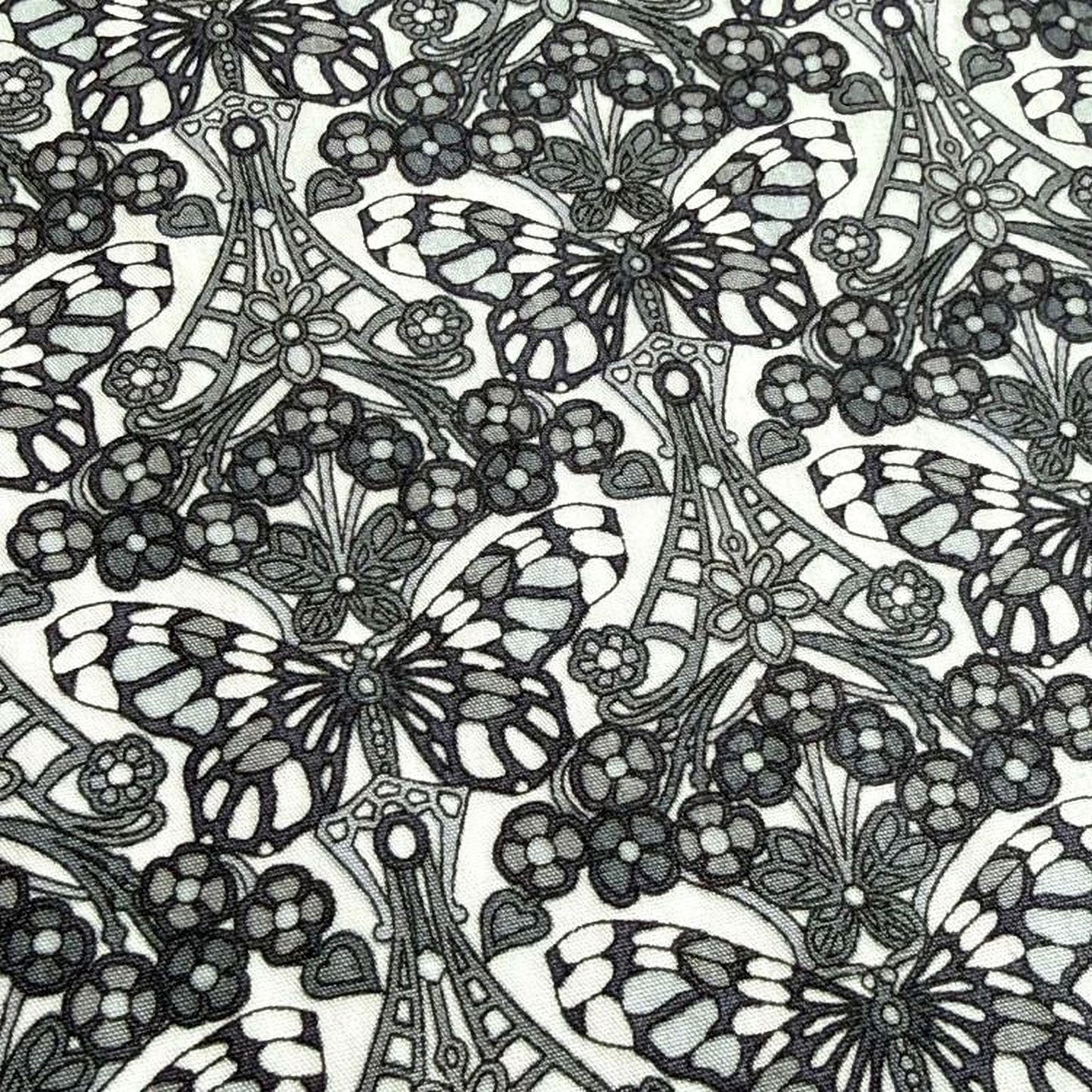 a repeating pattern of black and white butterflies and flowers, creating a visually striking and intricate design.