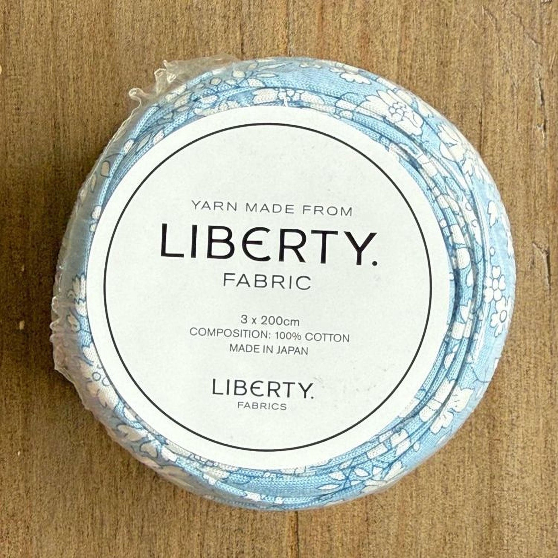 A label for a fabric product, specifically a spool of yarn made from the fabric.