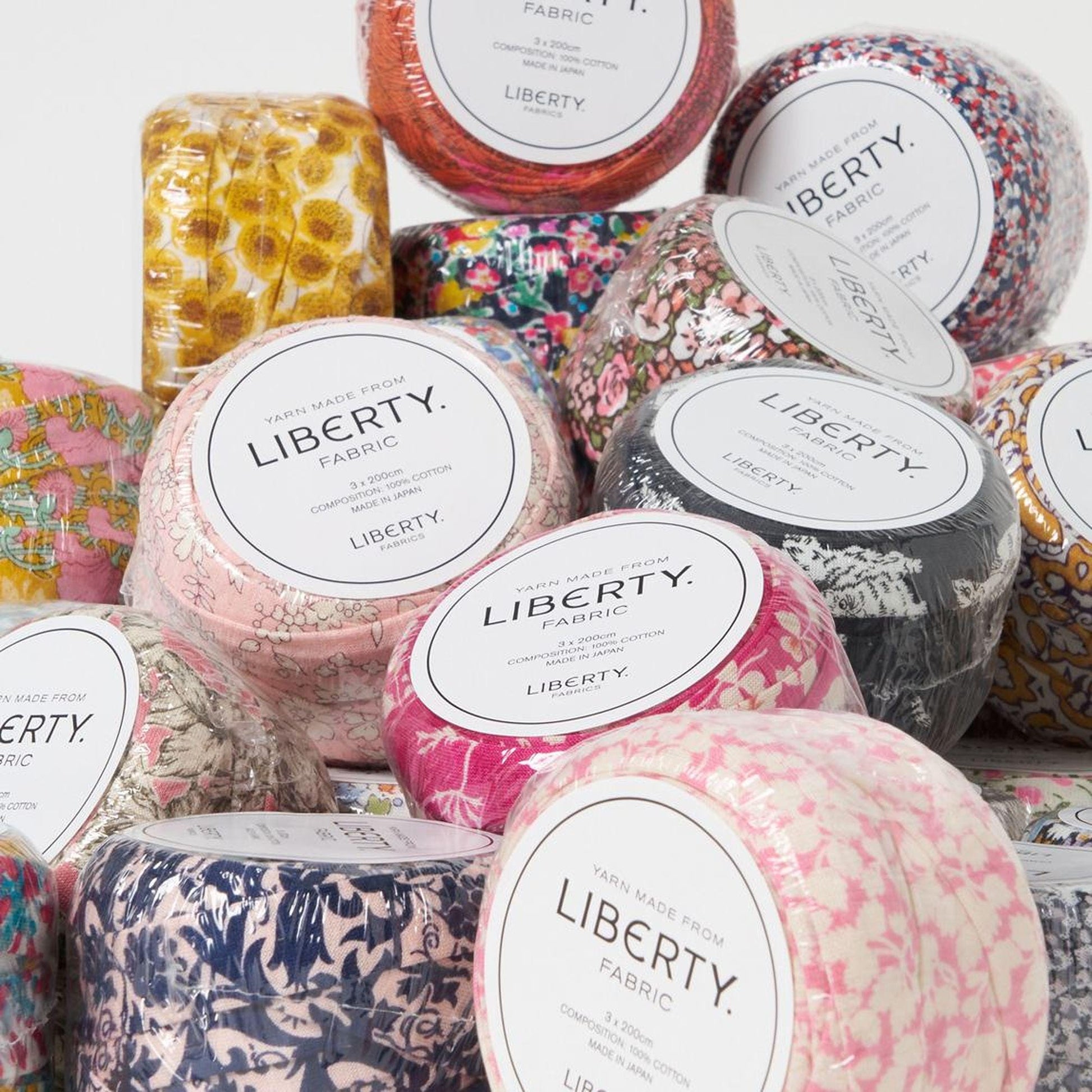 various fabric swatches and containers labeled "Liberty Fabric" in a visually appealing arrangement.