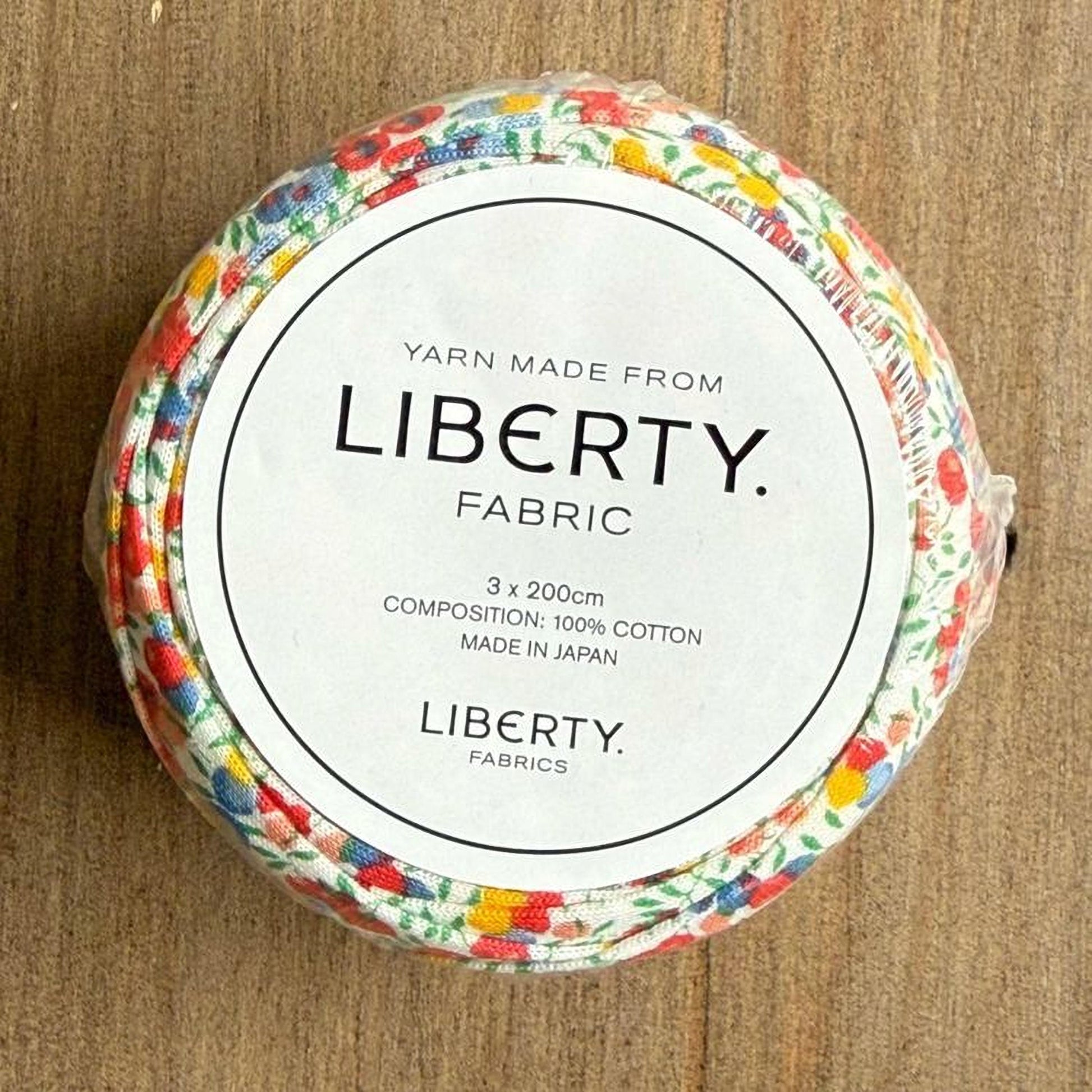 A package of Liberty fabric, with a label that reads "Yarn Made from LIBERTY FABRIC 3 x 200cm COMPOSITION: 100% COTTON MADE IN JAPAN LIBERTY FABRICS".