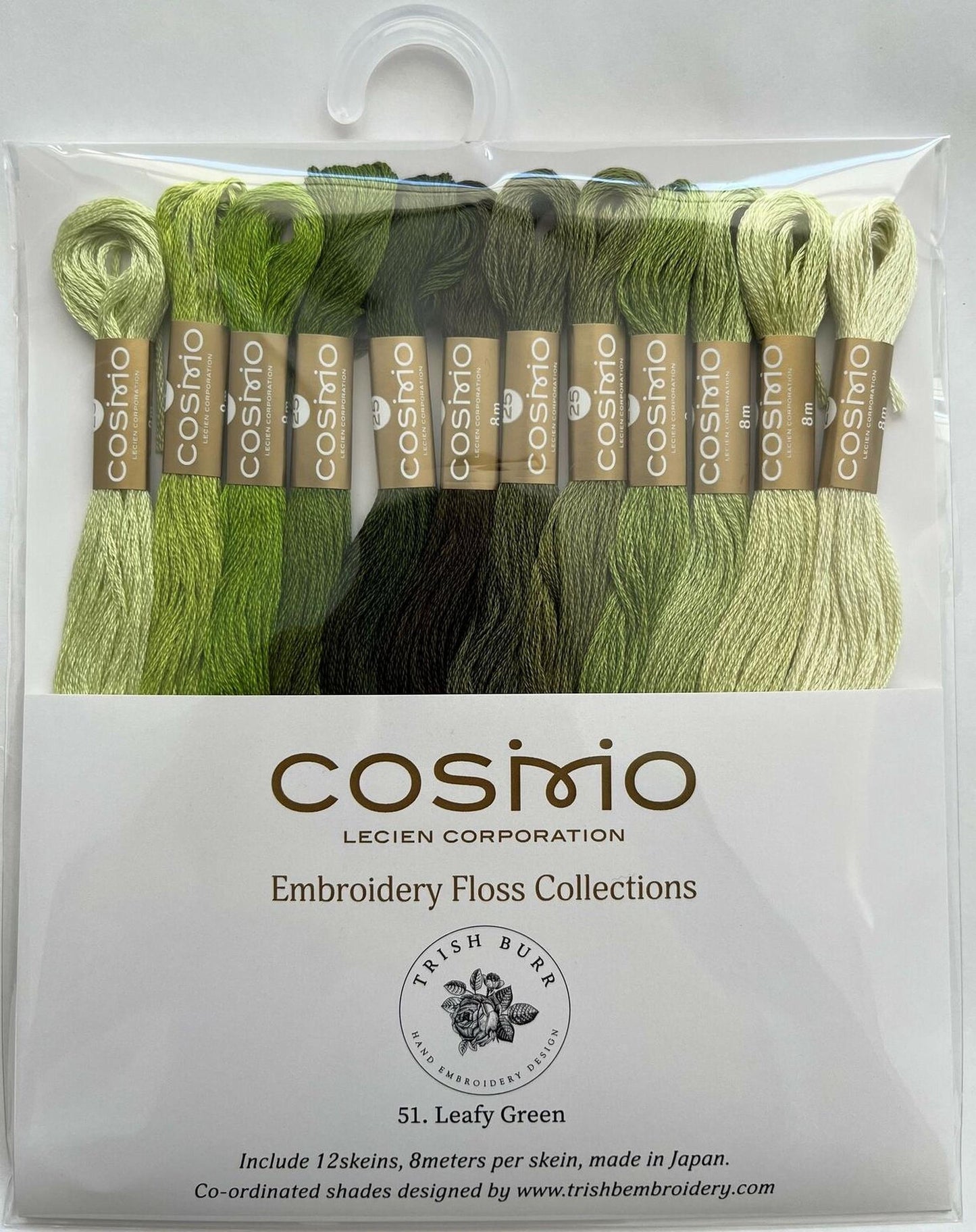 a package of embroidery floss in various shades of green, including a mix of lime green and mint green. The package is labeled as an embroidery floss collection from the brand Cosimo, and it includes 51 pieces of leafy green floss. The packaging also mentions that the floss is hand-ordered and made in Japan.
