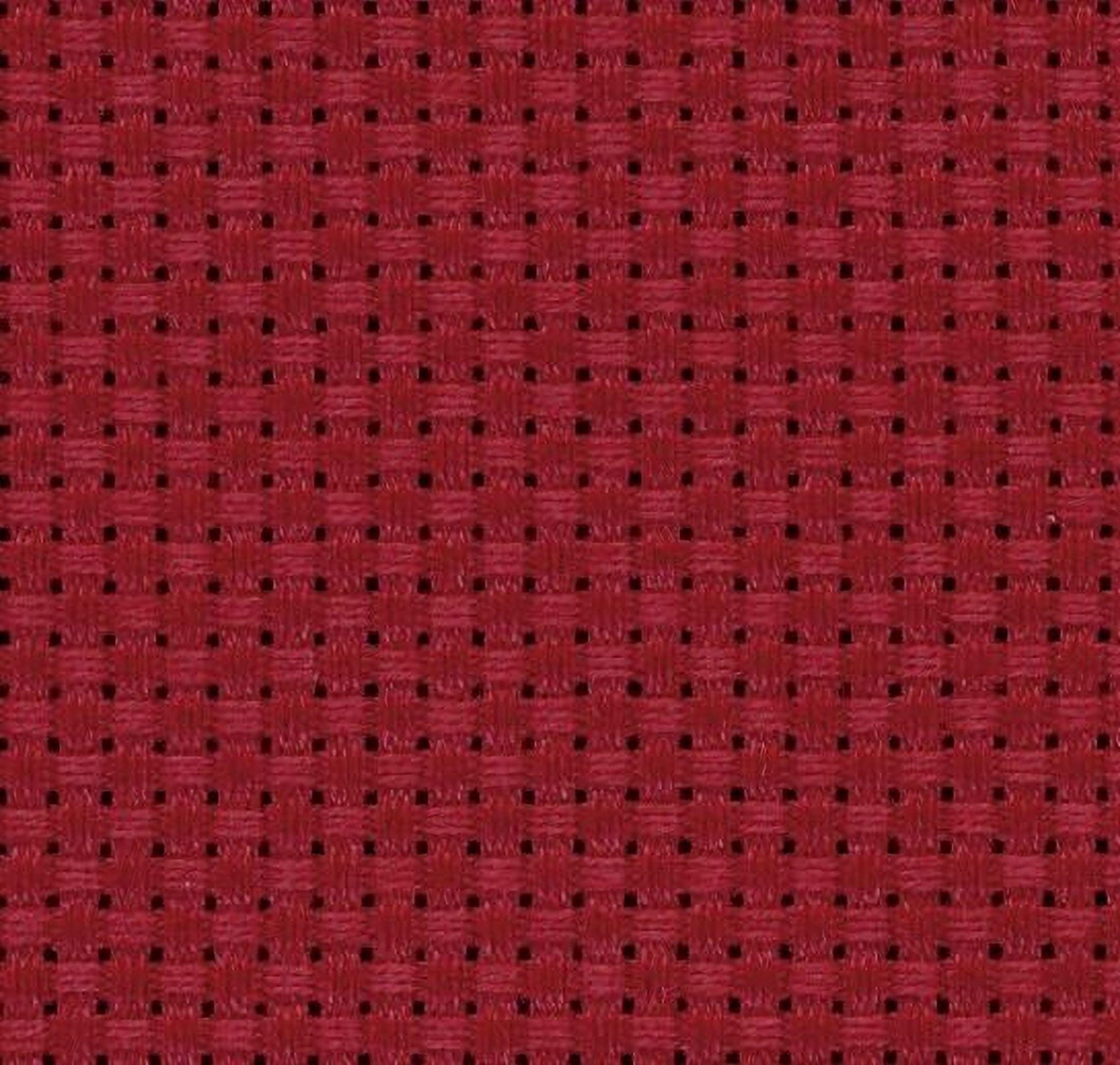 a close-up view of a red fabric with a woven pattern, featuring small squares or rectangles arranged in a grid-like pattern.