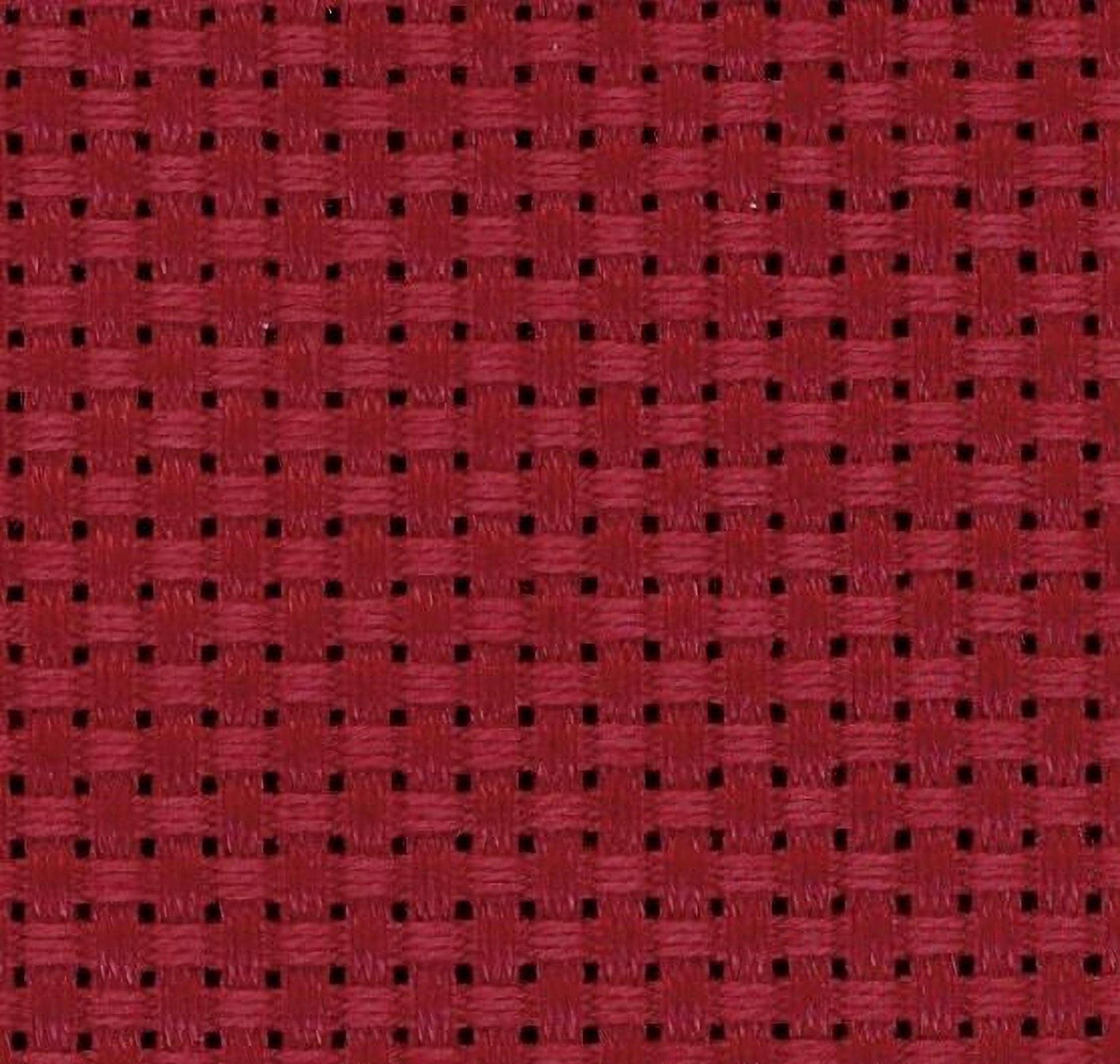 a close-up view of a red fabric with a woven pattern, featuring small square holes or perforations.