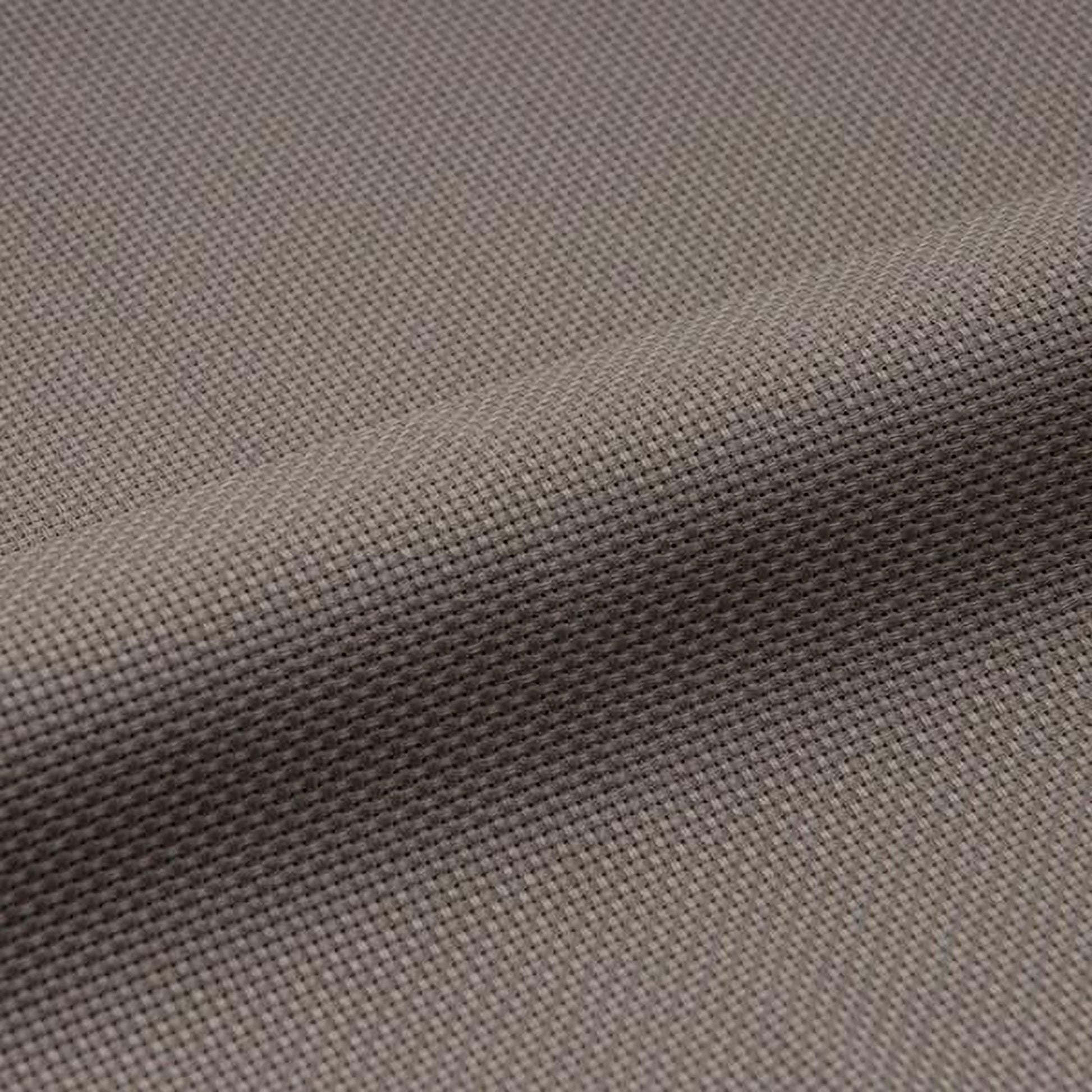 a close-up view of a textured fabric, possibly a piece of clothing or a textile. The fabric appears to be made of a woven material, with a repeating pattern of small squares or dots that create a textured surface. The image does not contain any text or other discernible objects or actions.