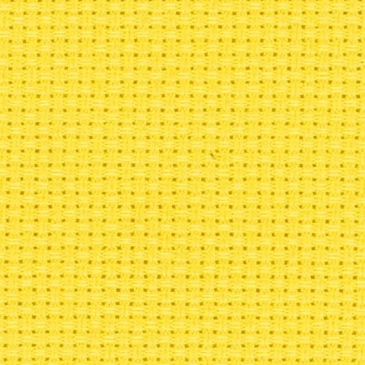 The image is a close-up of a yellow fabric with a grid-like pattern, which appears to be a cross-stitch design.