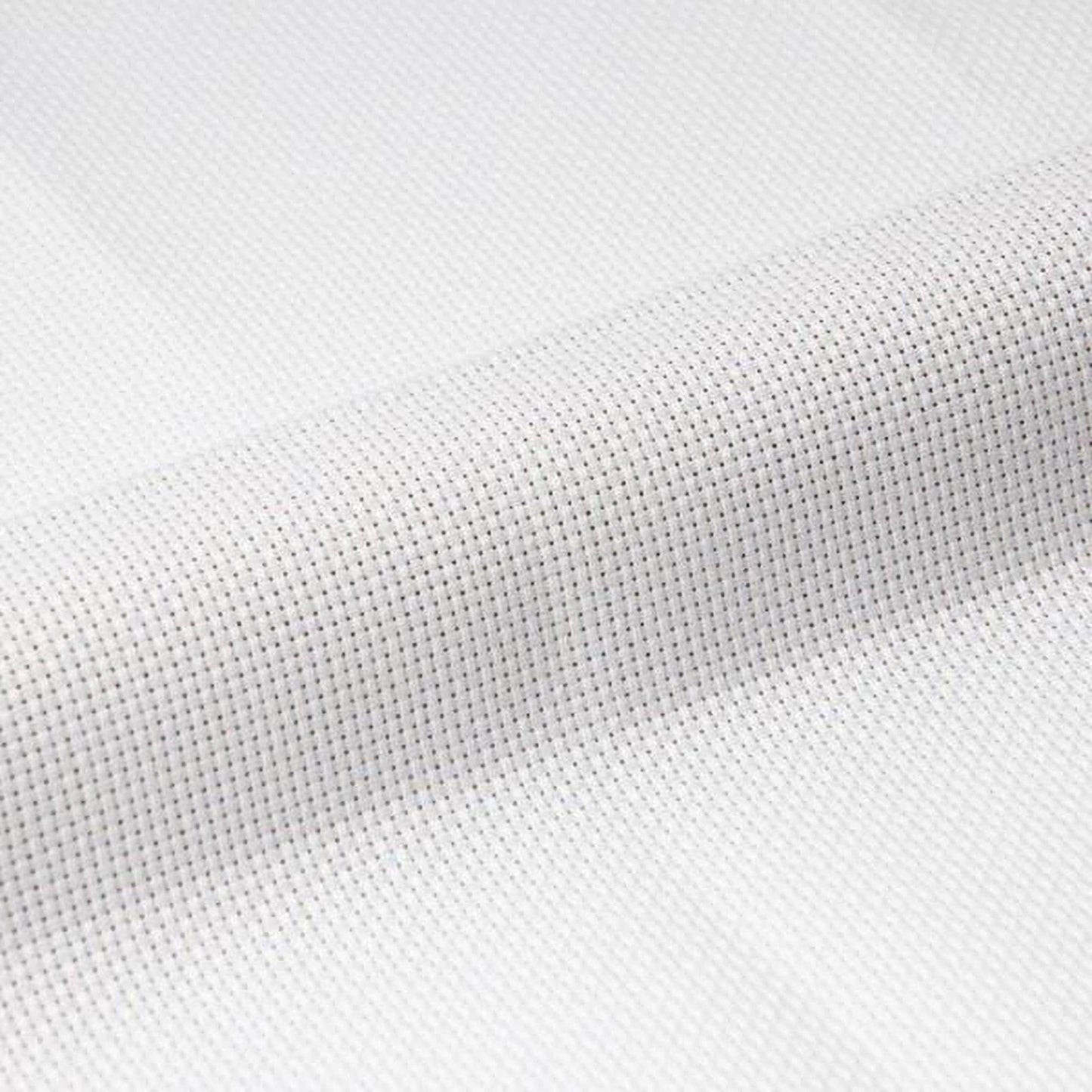 A close-up view of a white fabric with a cross-stitch pattern, featuring small white dots arranged in a grid-like pattern.