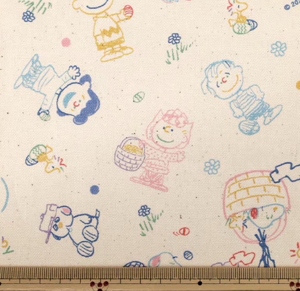 The image is a collage of various cartoon characters and illustrations, including Peanuts characters, on a fabric with a white background.