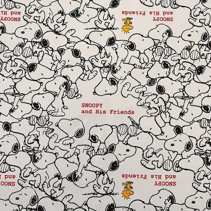 The image is a repeating pattern of various cartoon characters, including Snoopy, arranged in a grid-like layout. The characters are depicted in a stylized, black and white manner, creating a visually striking and playful design.
