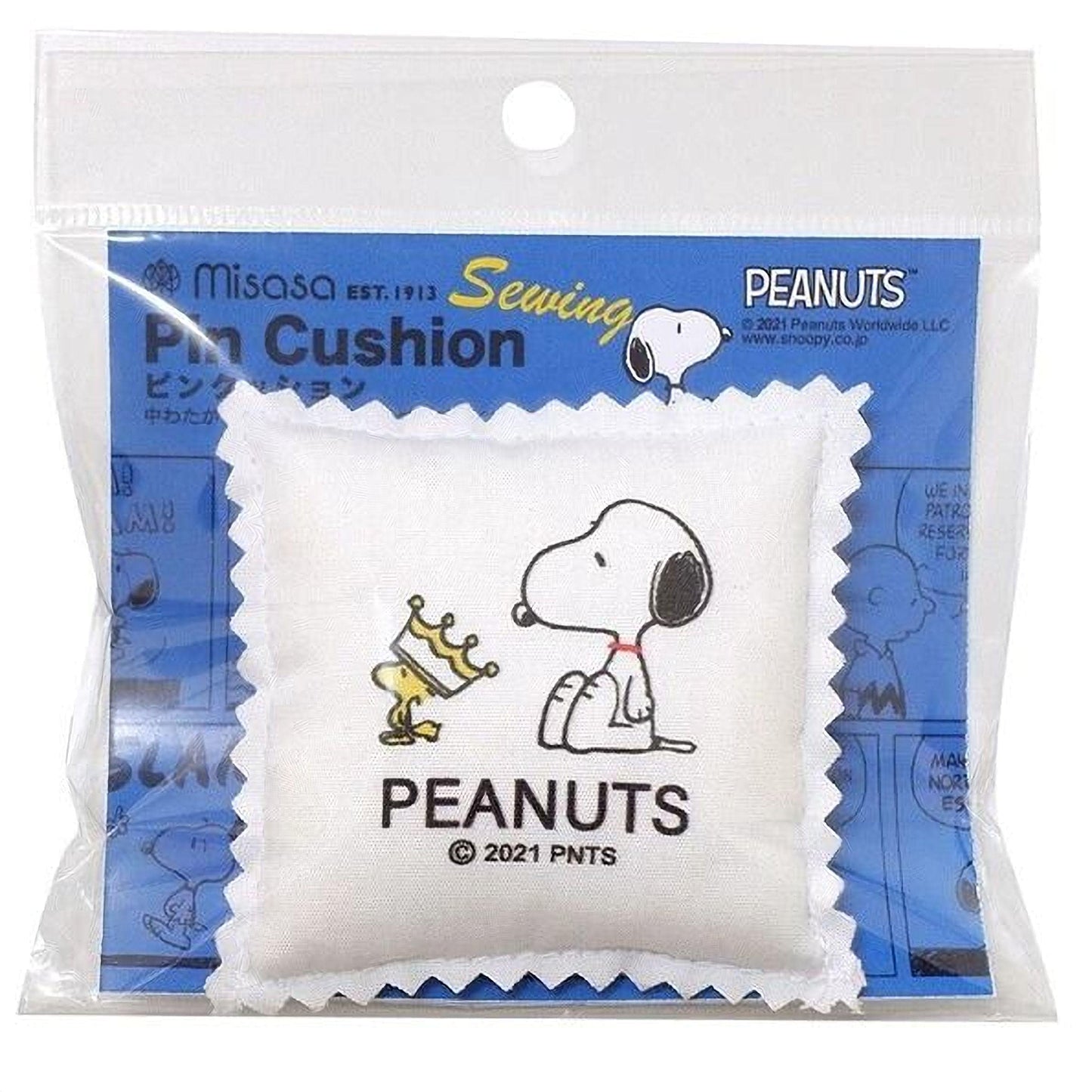 A sewing pin cushion featuring a cartoon image of a dog wearing a crown and holding a trophy, with the text "Peanuts" and "© 2021 PNTS" printed on it.