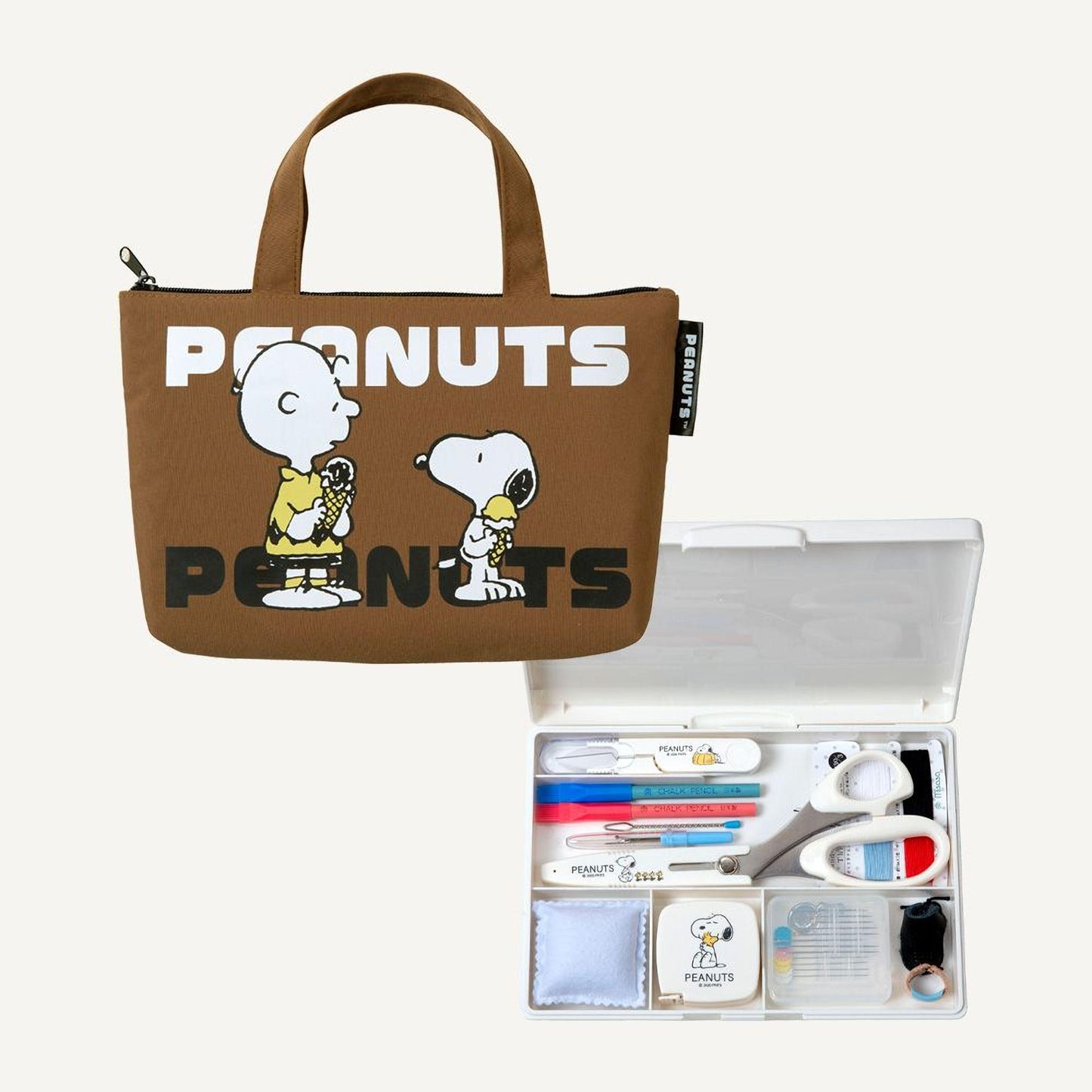 a brown tote bag with the word "PEANUTS" printed on it, and a small plastic organizer with various items such as scissors, pens, and other office supplies.